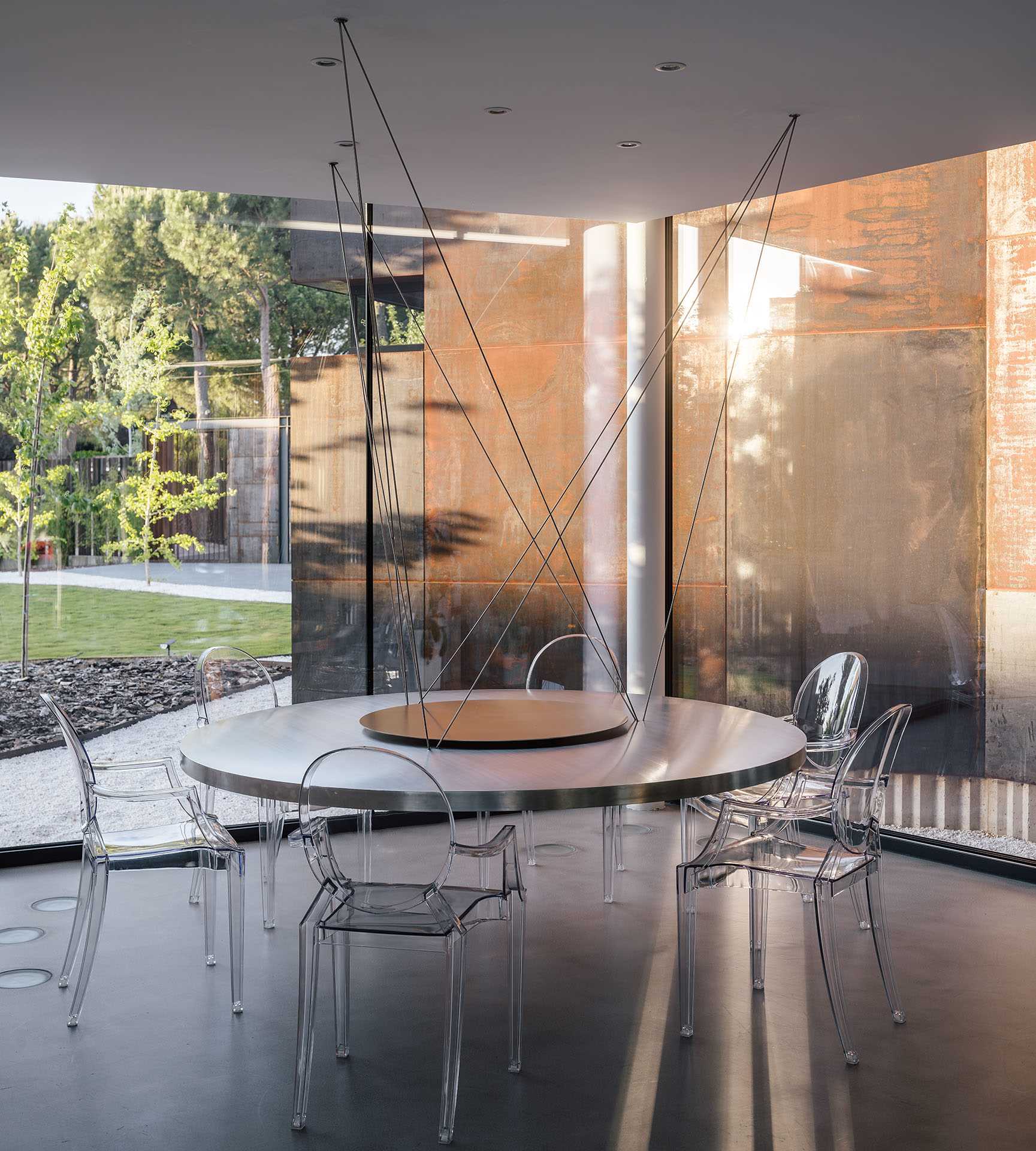 In the dining room, the table is suspended by cables from the ceiling, creating a unique sculptural element that's also functional.