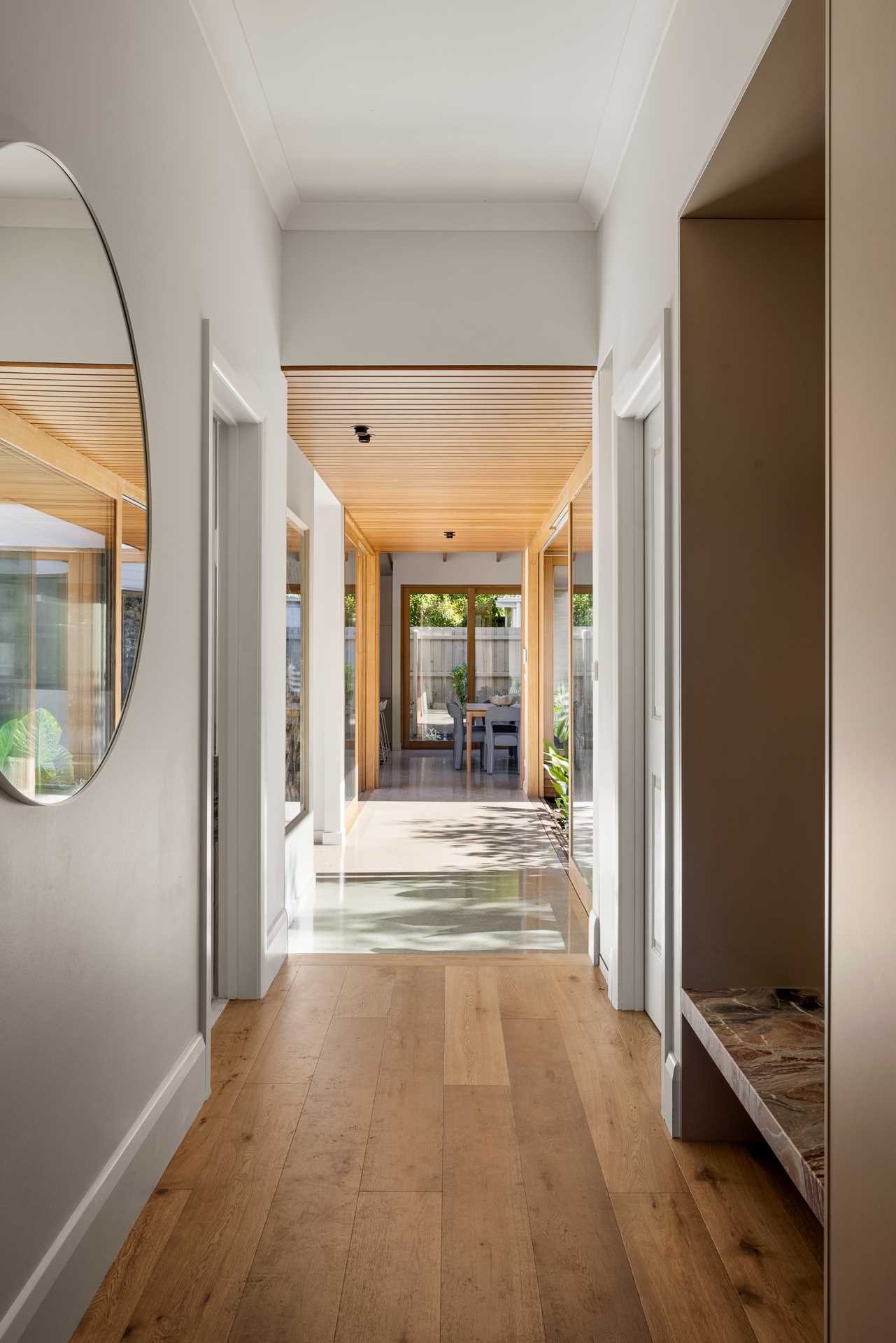 The view from the front door shows off the hallway that connects the original home with the new extension.