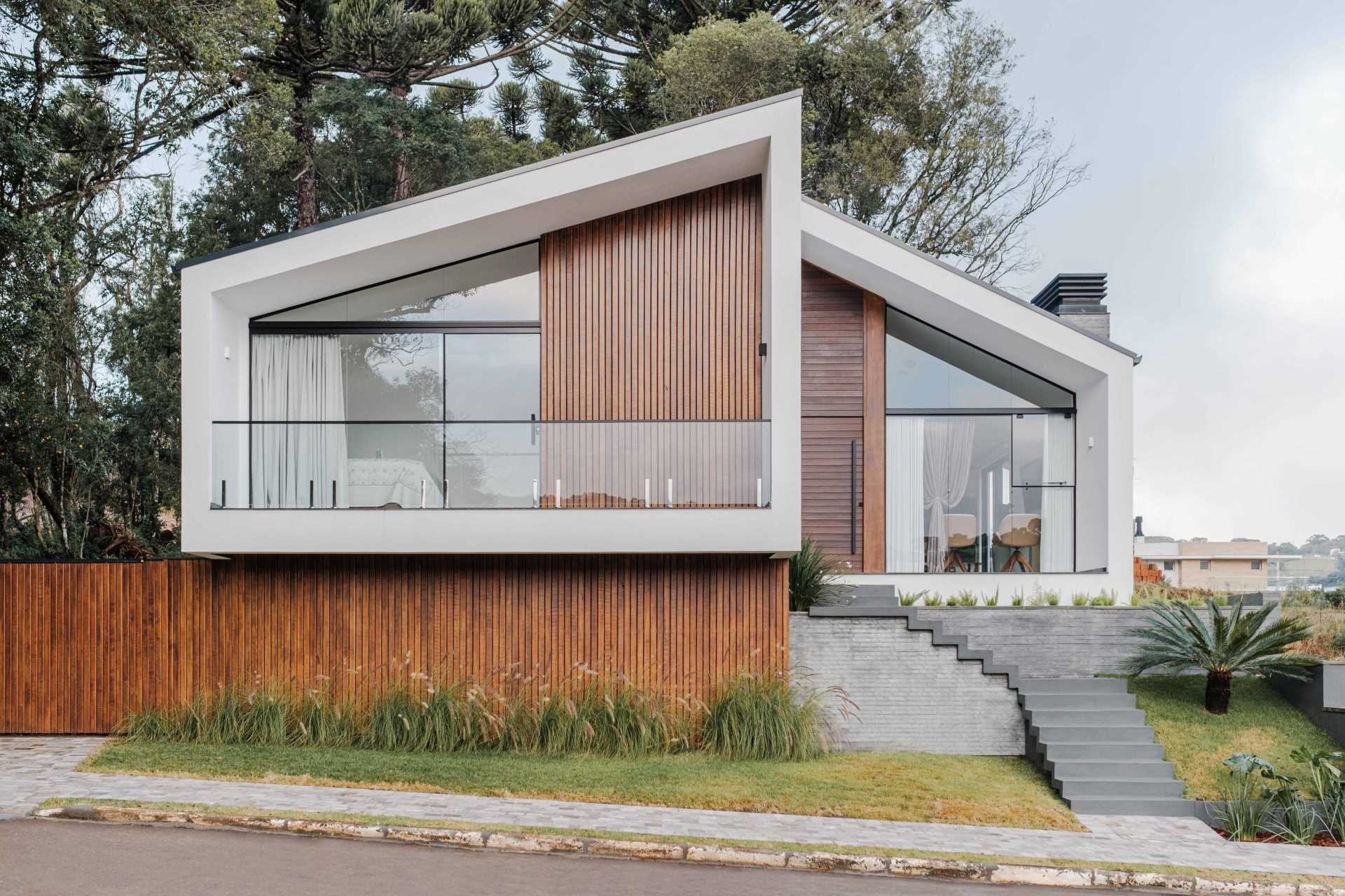 The design of this modern home shows off a modern reinterpretation of the gabled roof archetype.