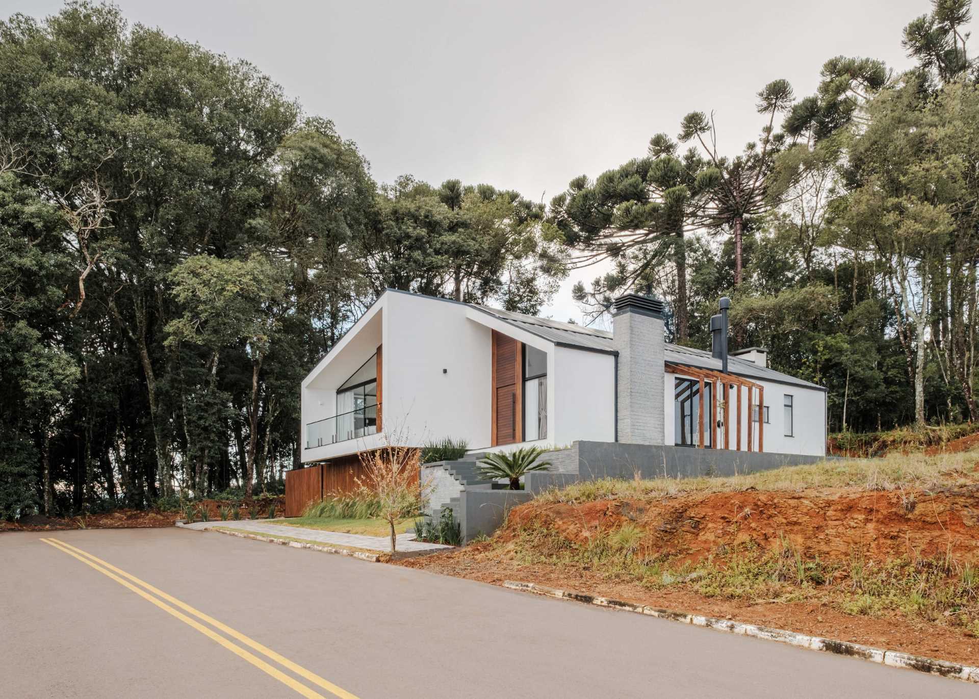 The design of this modern home shows off a modern reinterpretation of the gabled roof archetype.