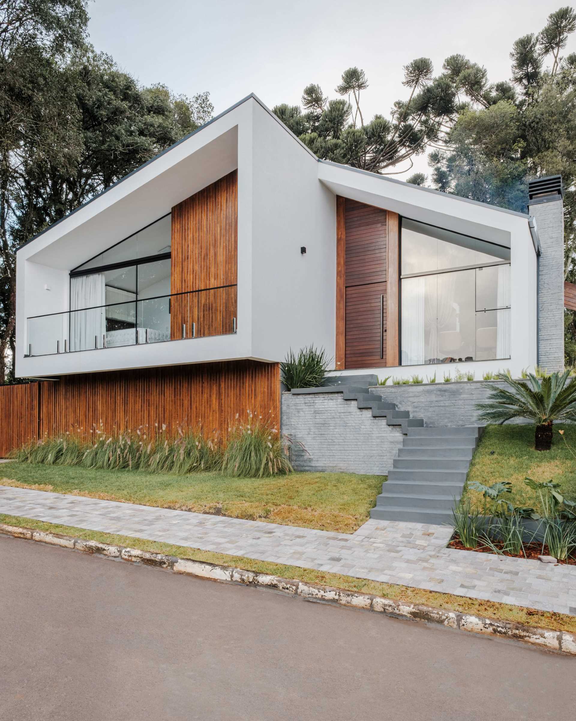 The design of this modern home shows off a modern reinterpretation of the gabled roof archetype.