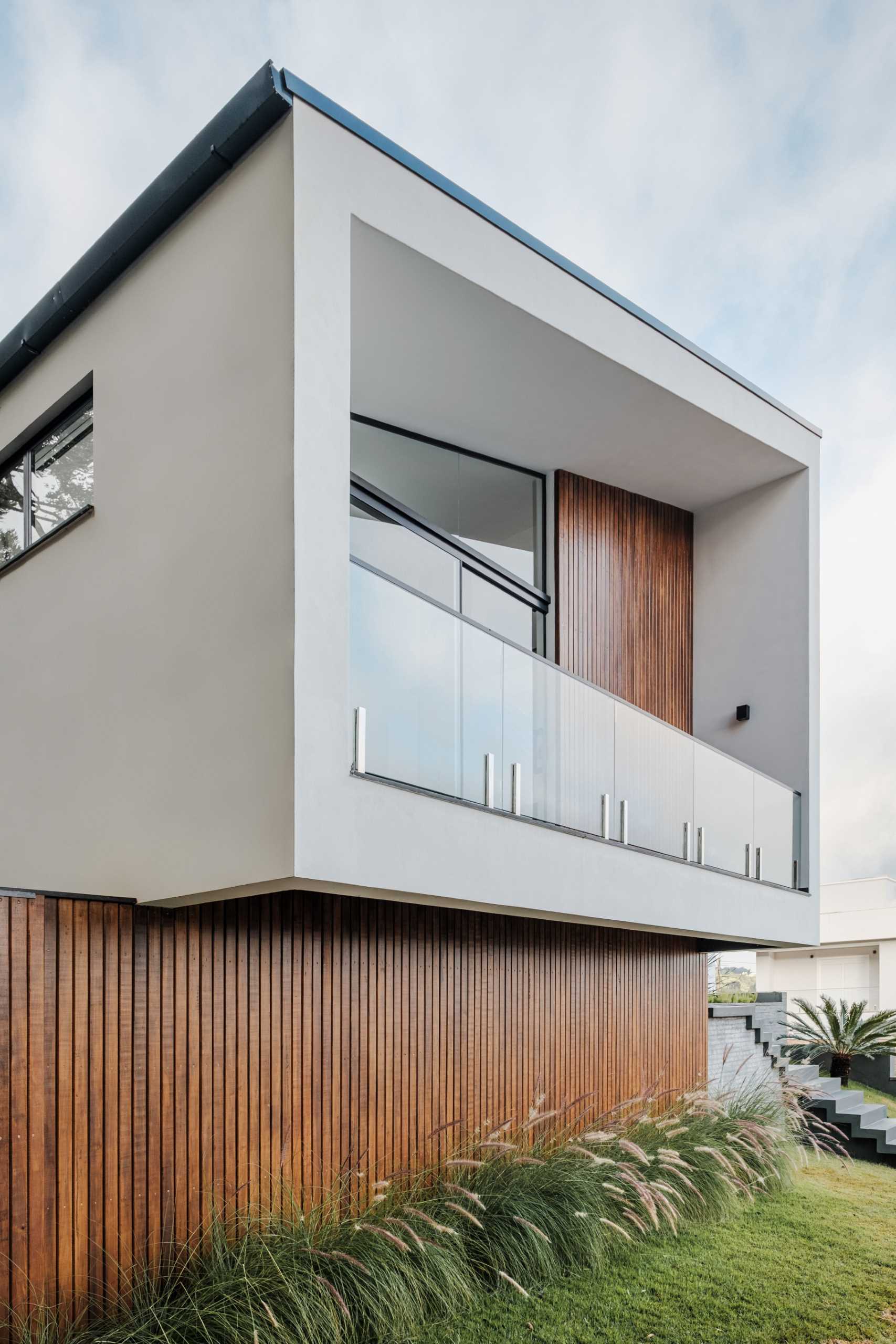 The design of this modern home shows off a modern reinterpretation of the gabled roof archetype.