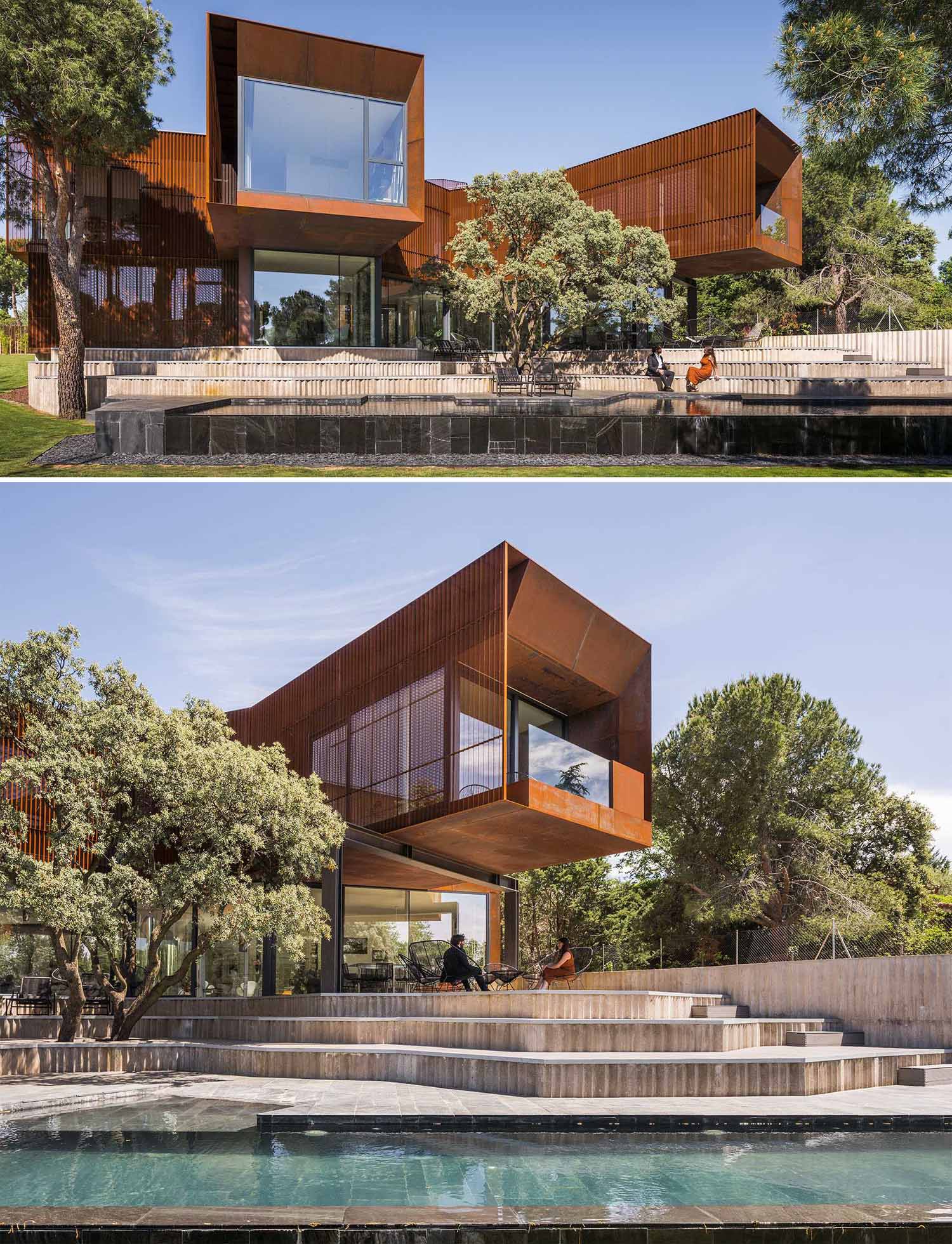 A modern house features large windows, cantilevered elements, and a weathered steel facade.