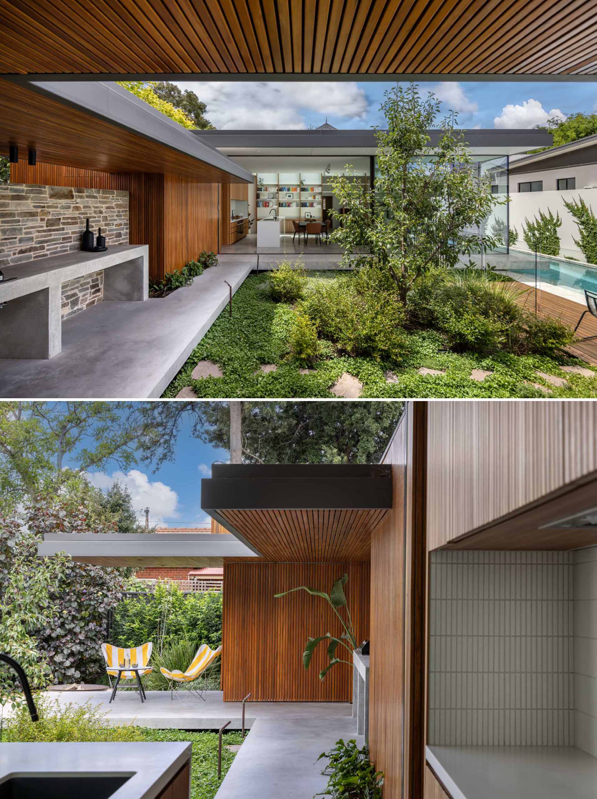 A stone wall alongside a path, includes an area for an outdoor kitchen with a bbq.