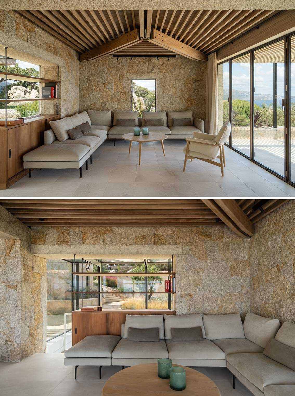 In the living room, there's an Iroko wood ceiling, Orosei marble flooring, San Giacomo yellow granite masonry, and burnished brass folding window frames.