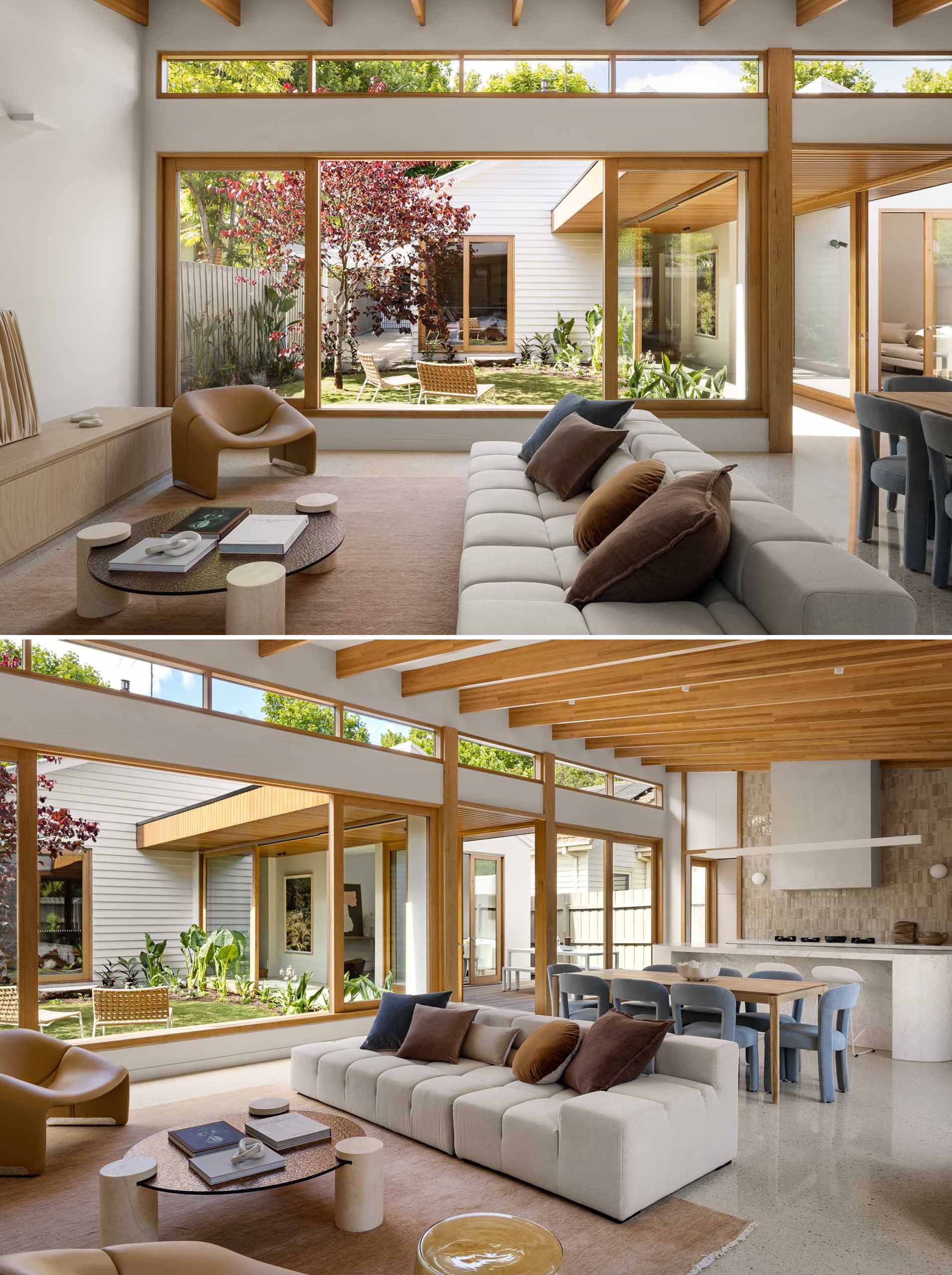 The new extension includes a large open-plan room with a living room at one end. The cathedral ceiling and high-level glazing lifts your eyes over the original dwelling, while the exposed timber beams add to the sense of warmth and detail.