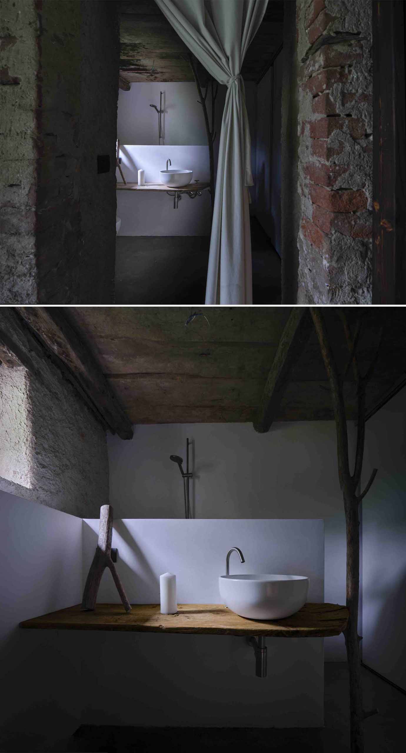 The bathroom of an off-grid home includes a vanity, toilet, and shower.