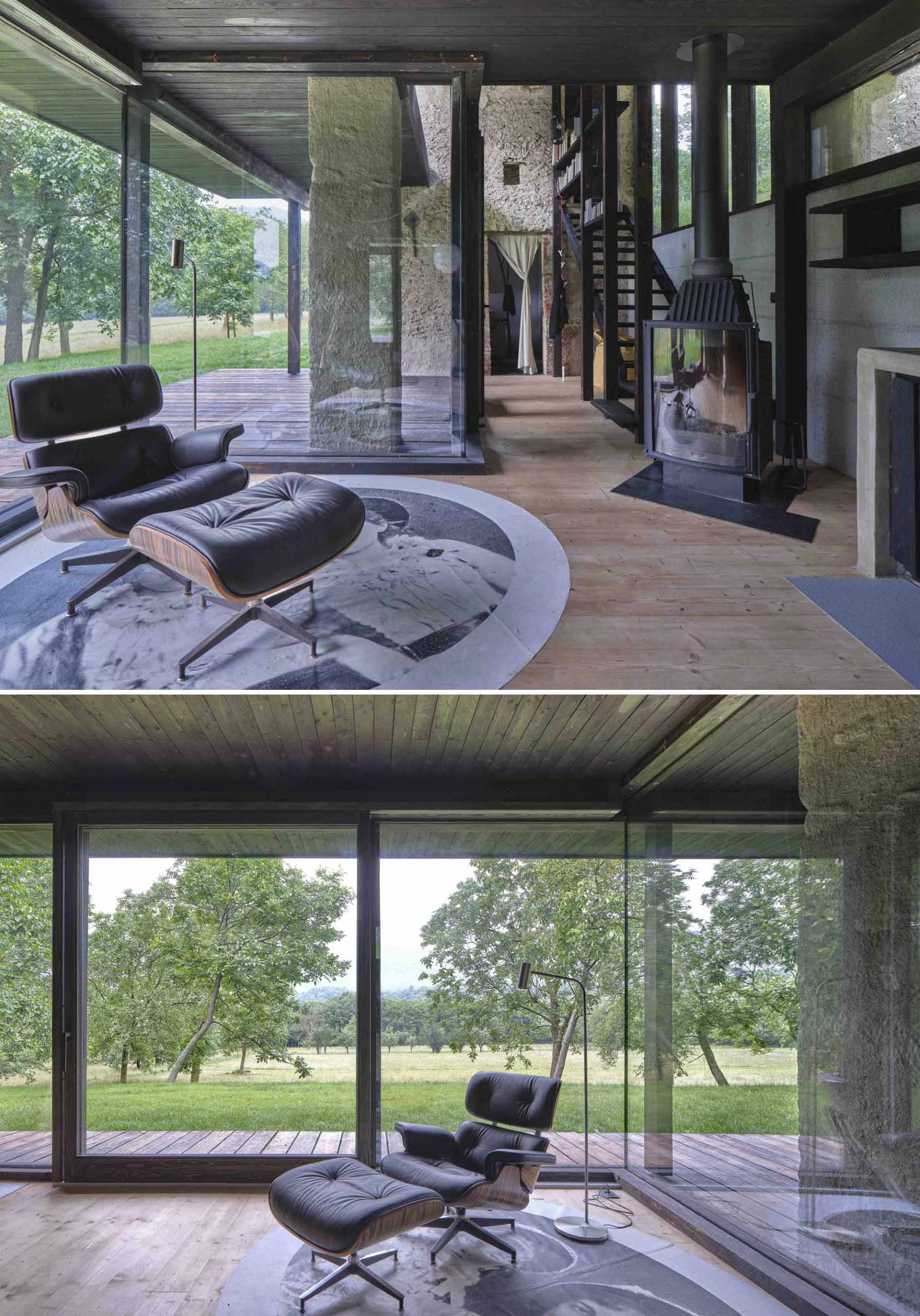 A small off-grid home with burnt larch wood and large windows, includes a sitting area with a fireplace.