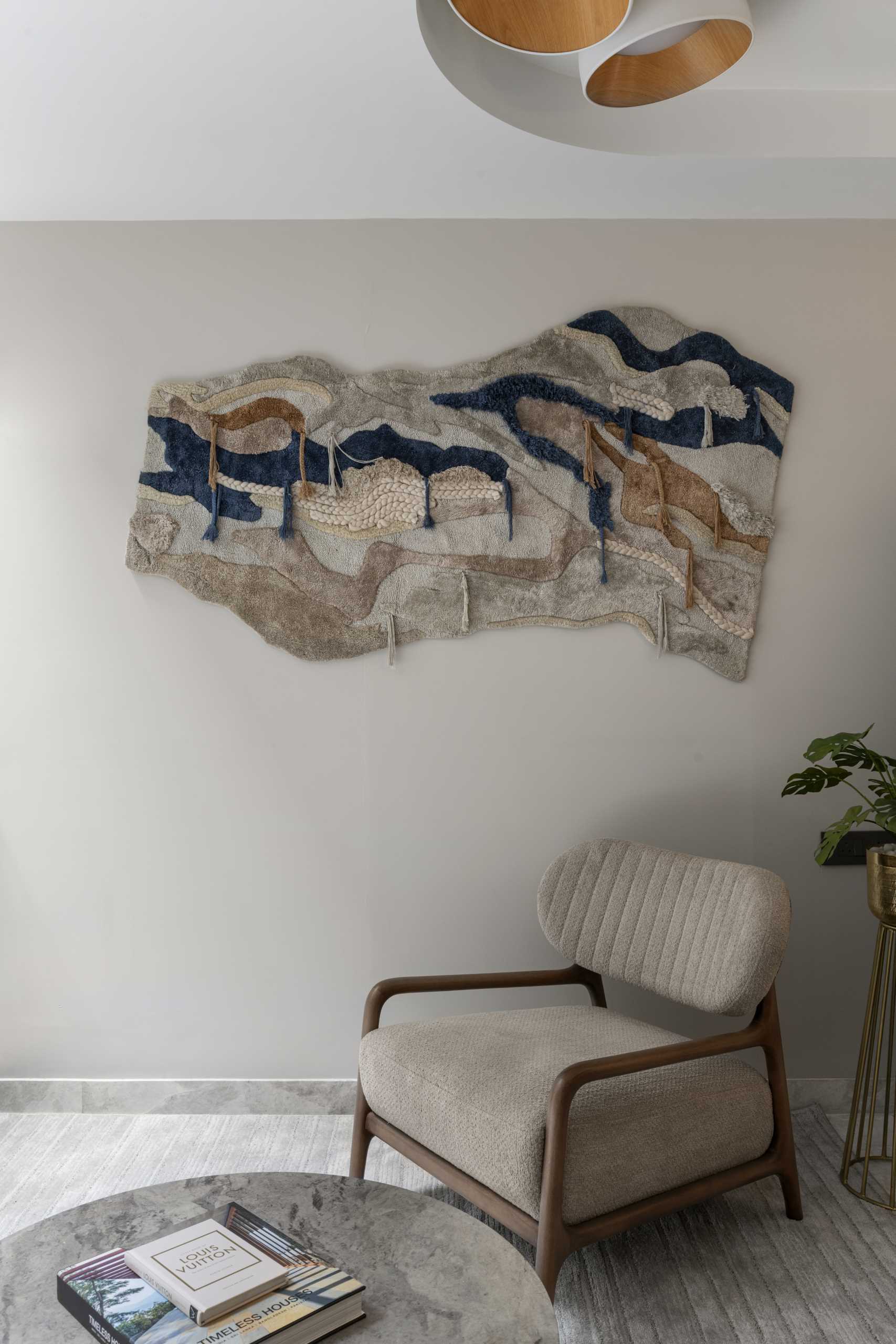 A contemporary sitting area with a textural piece of wall art.