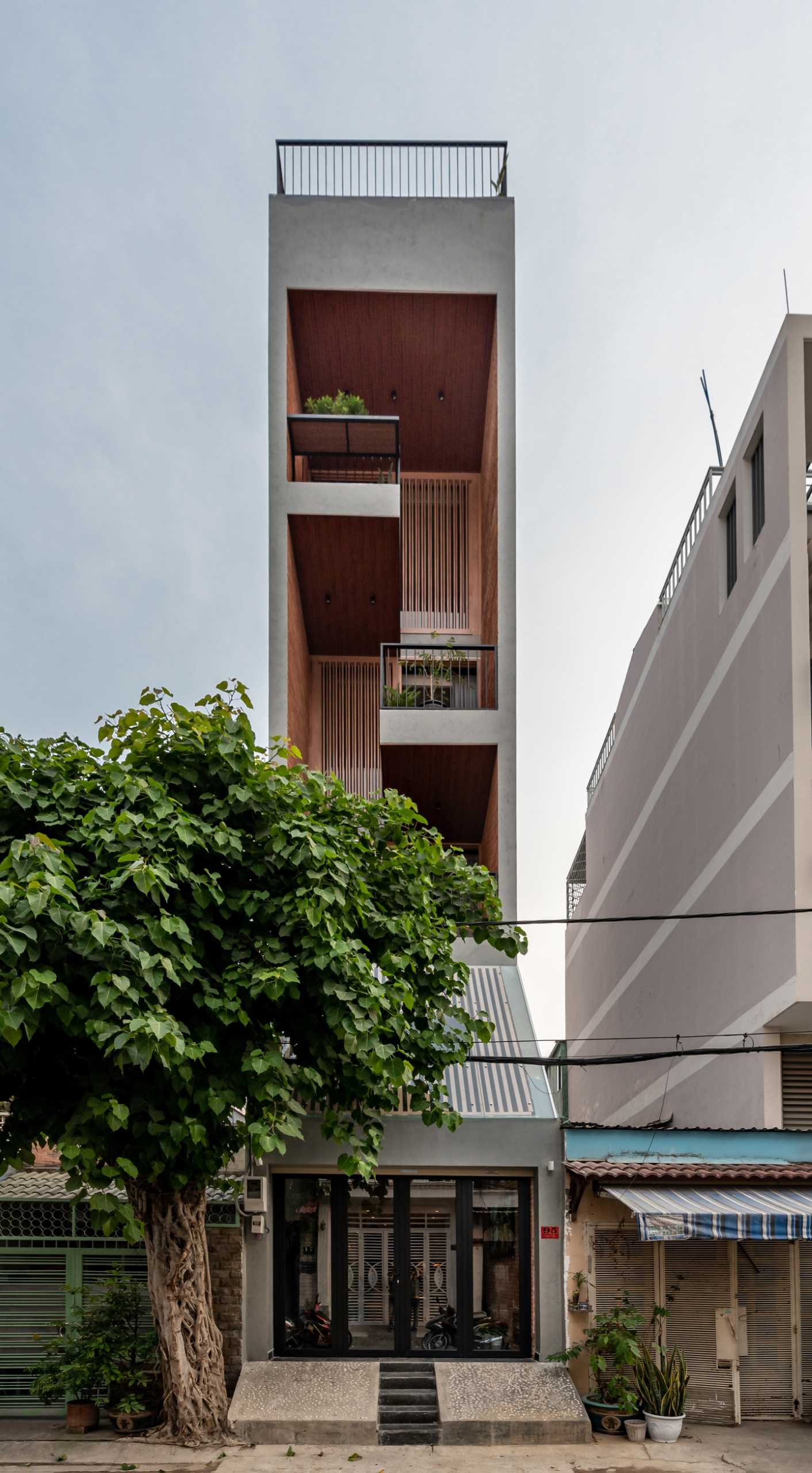 A tall and skinny house with six levels, including a rooftop pool.