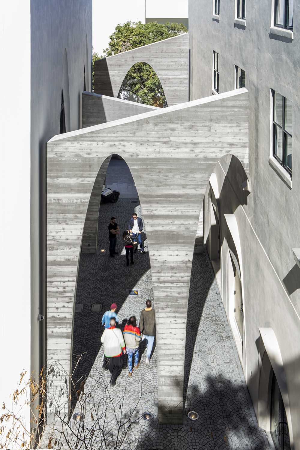 A series of arches were added to a nondescript alley to create an art installation that added life to the area.