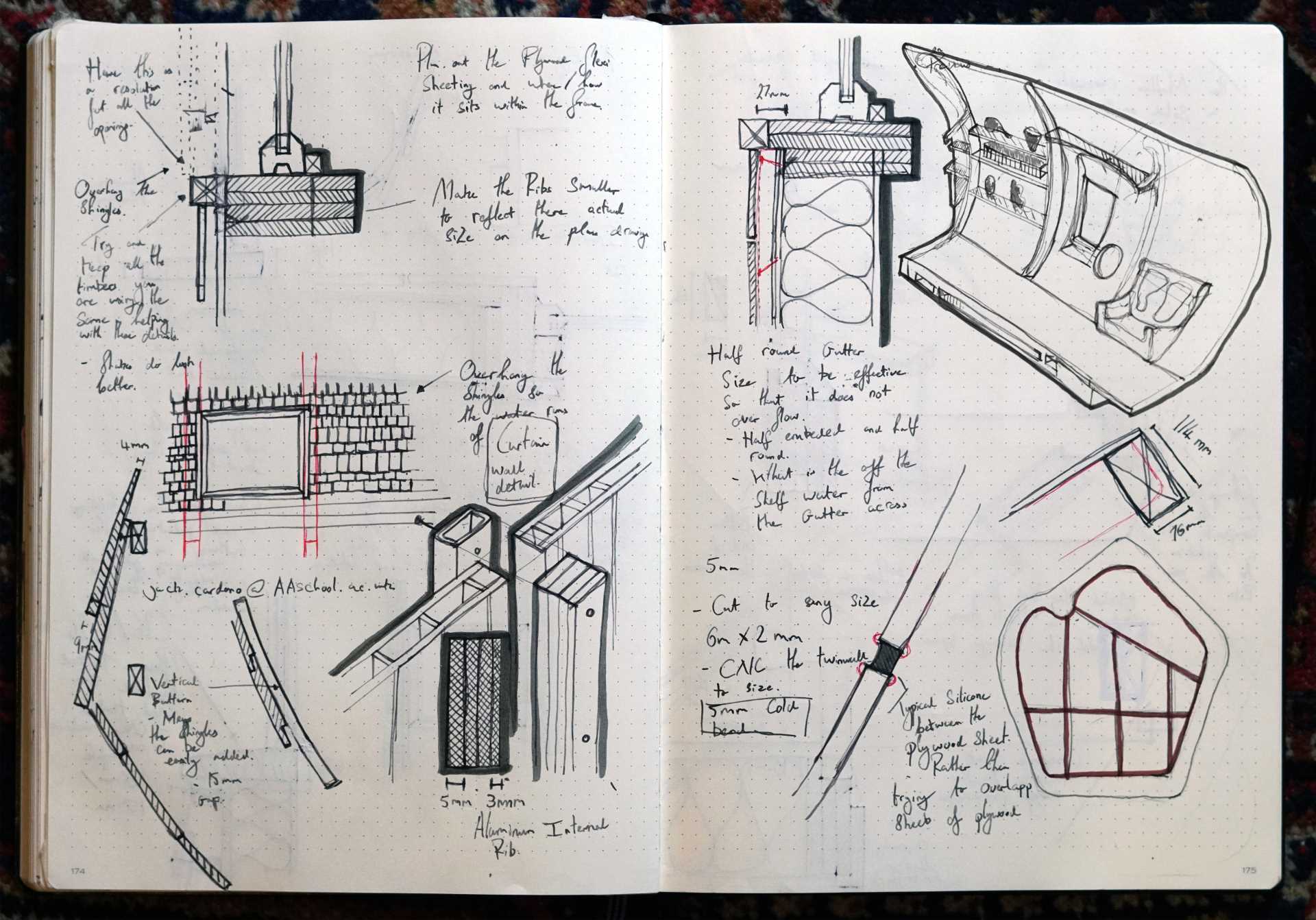 A small ،ically shaped cabin clad in wood ،ngles.