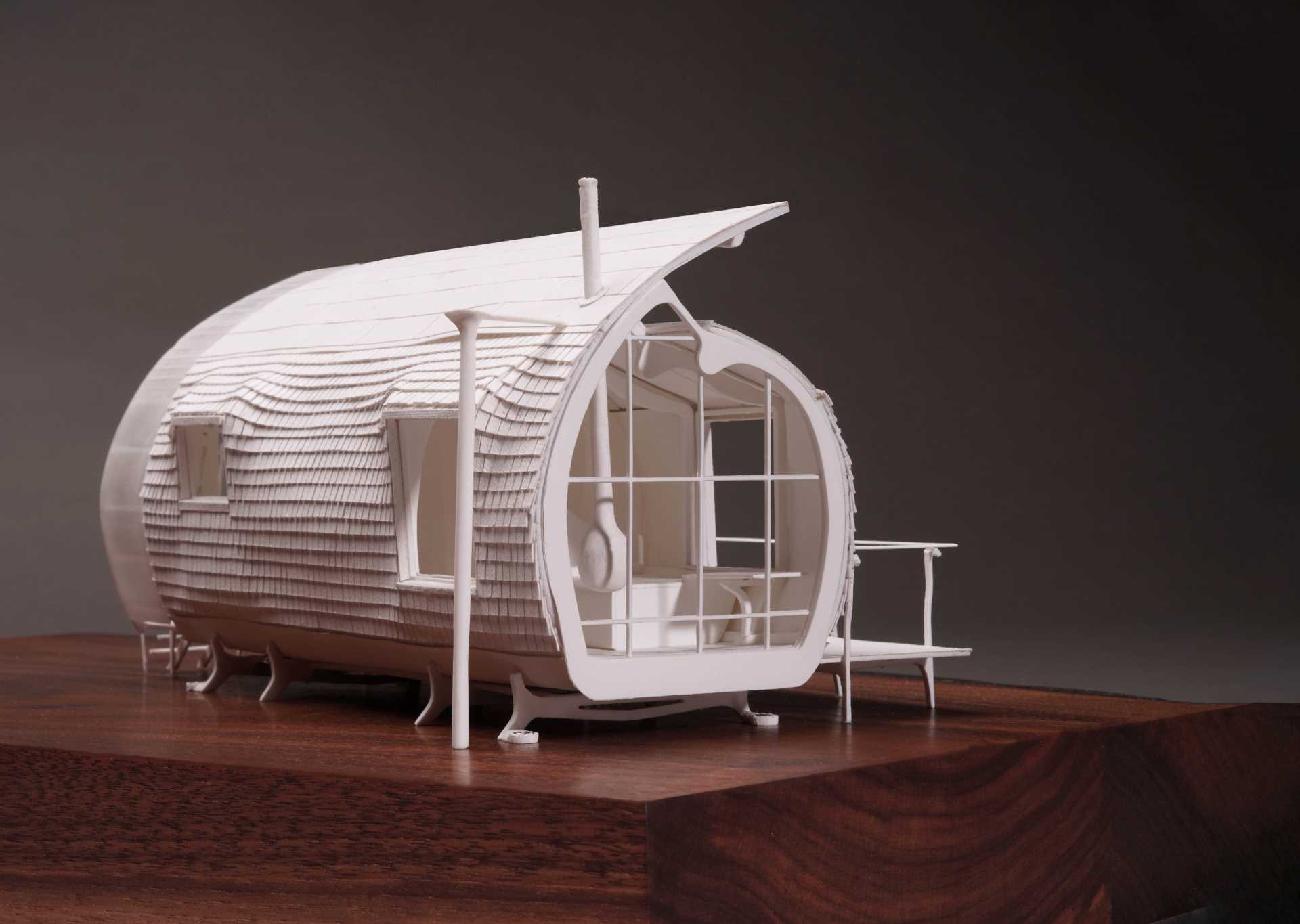 A small ،ically shaped cabin clad in wood ،ngles.