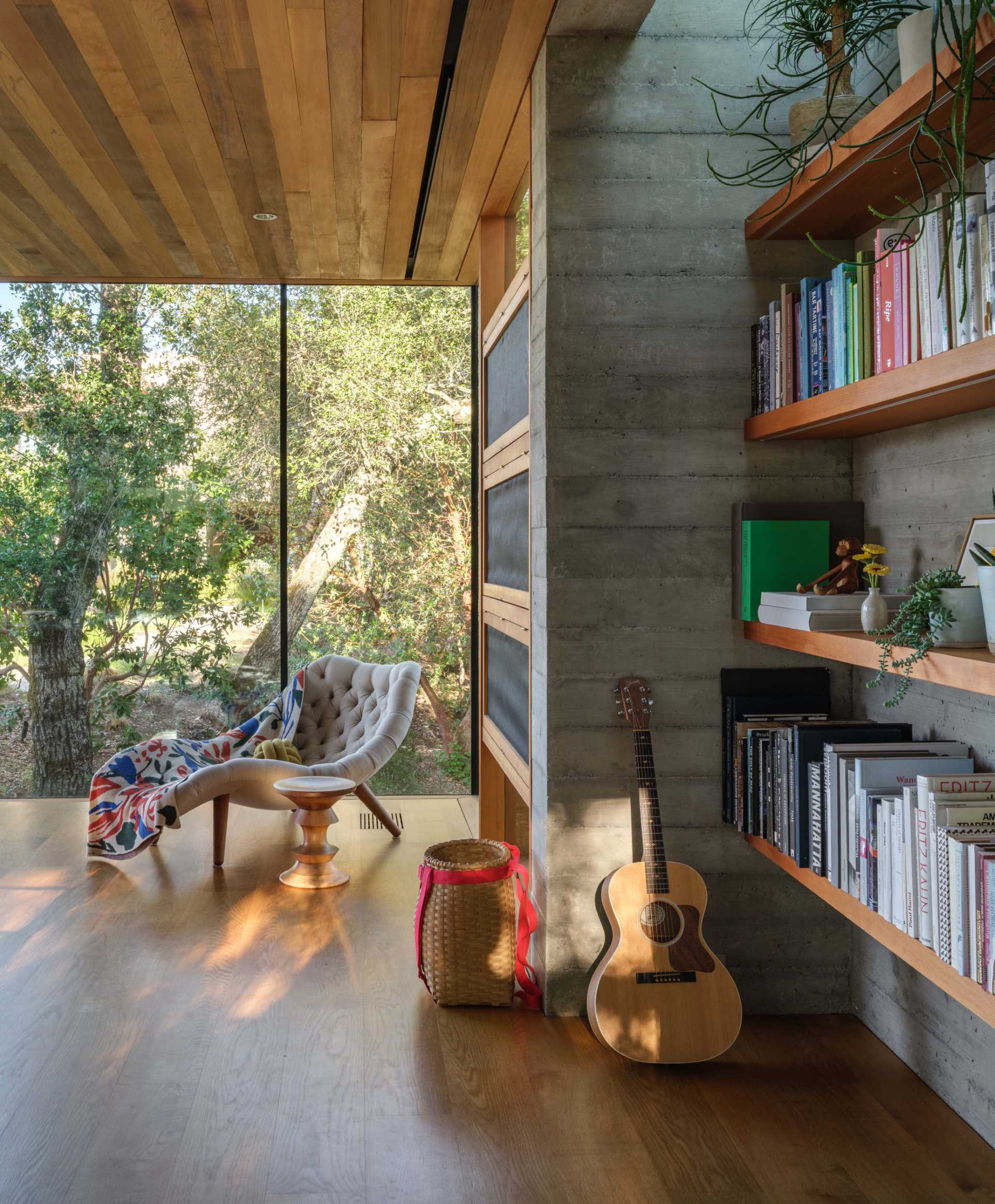 A wood-framed glass box is home to a backyard office.