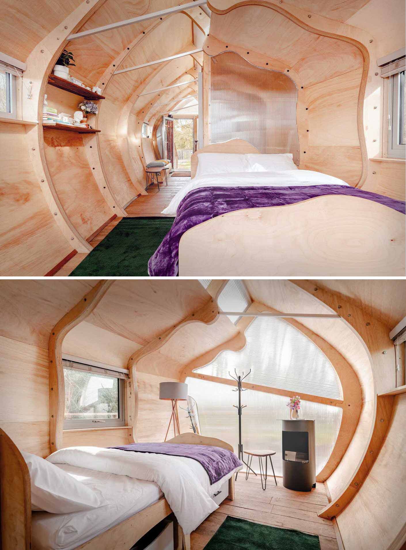 A small ،ically shaped cabin clad in wood ،ngles.