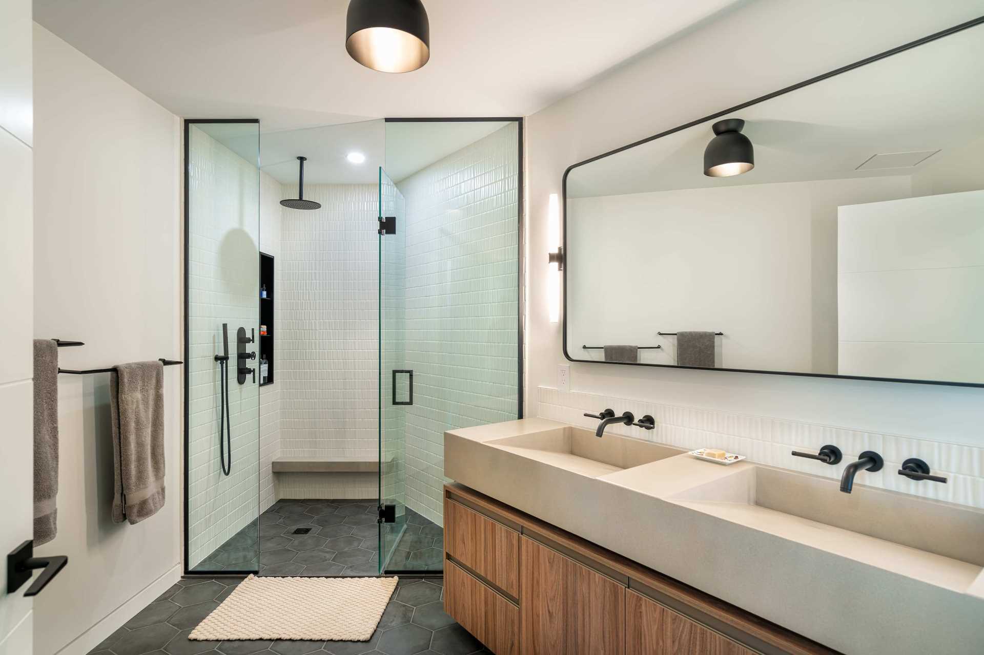 A uniquely shaped angled ensuite includes a walk-in shower with a bench, and a double vanity.