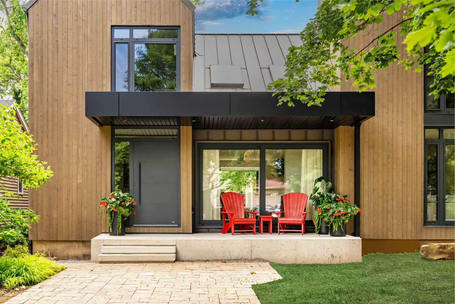 This 1980s home was transformed to include Scandinavian influence externally, and playful sophistication within, while neutral wood tones found in the vertical exterior siding, creates an intimate connection with its scenic lakeside locale.