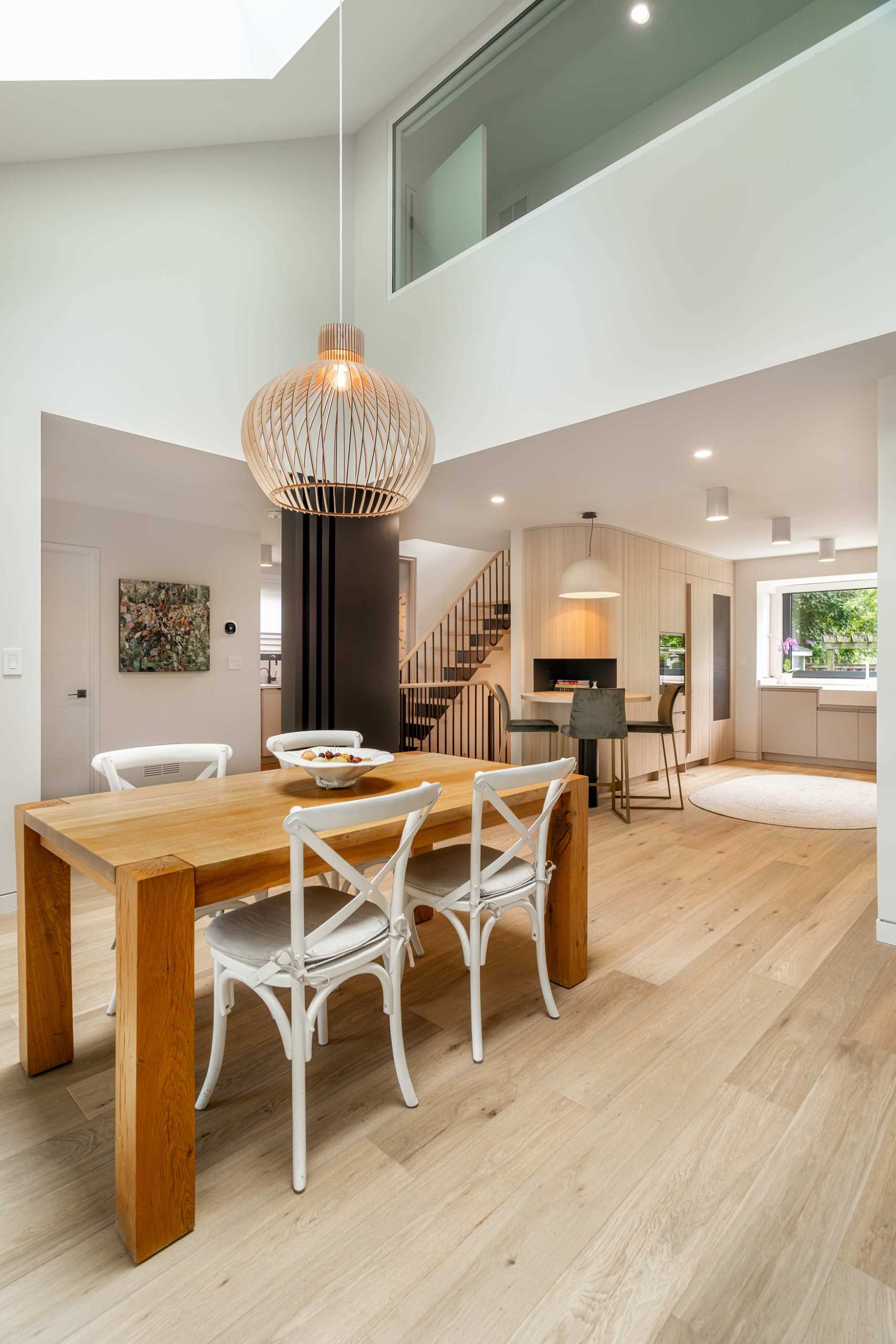 An open plan dining area with a wood table.