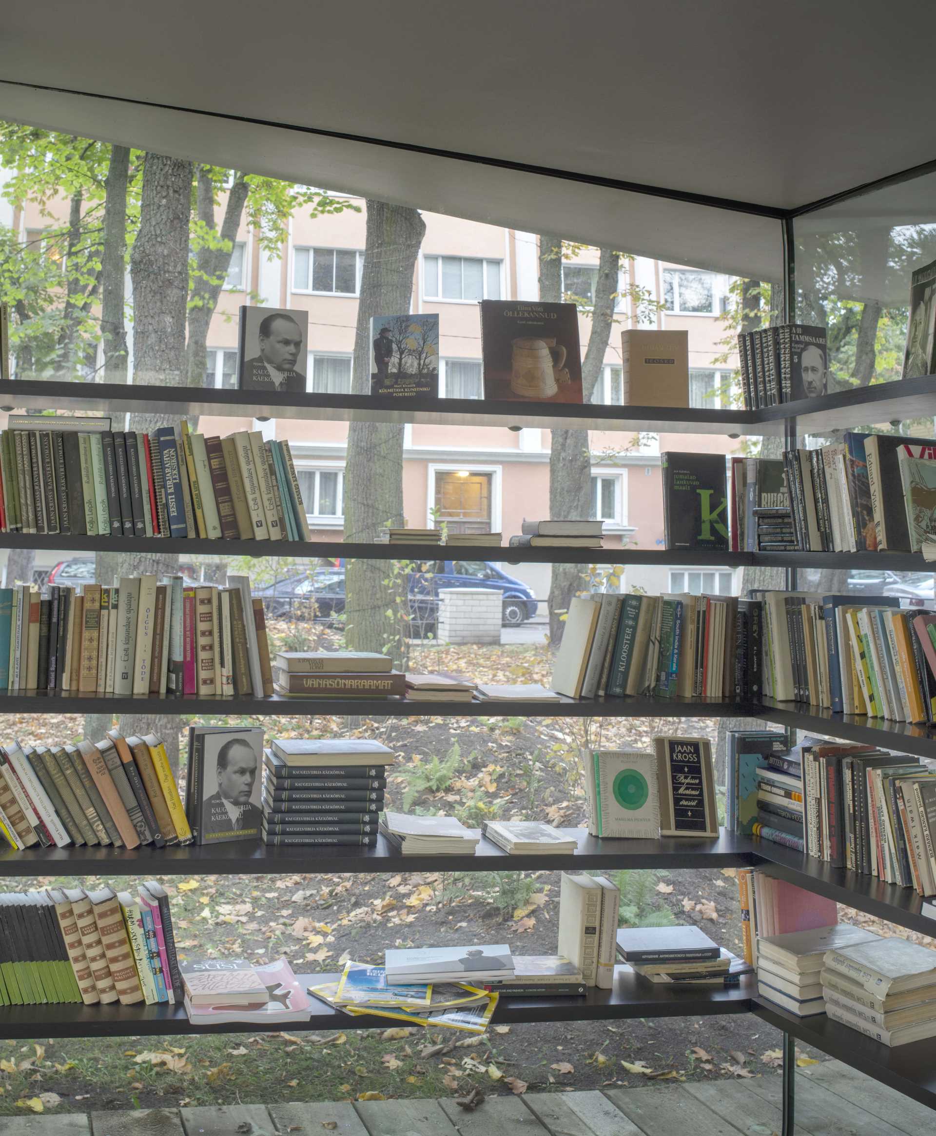 A small public library with glass walls and a white roof that's inspired by a sheet of paper.