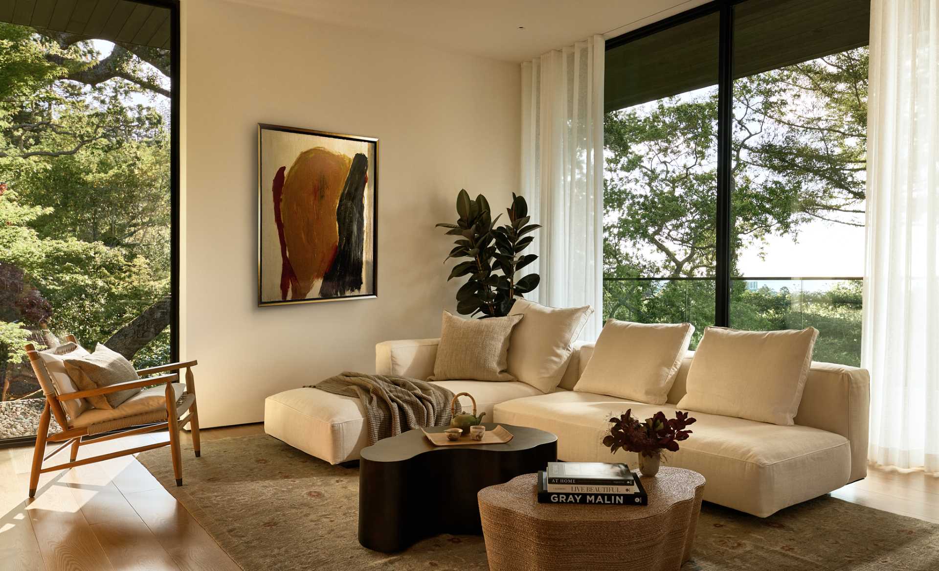 A living room with a cozy atmosphere and views of the trees.