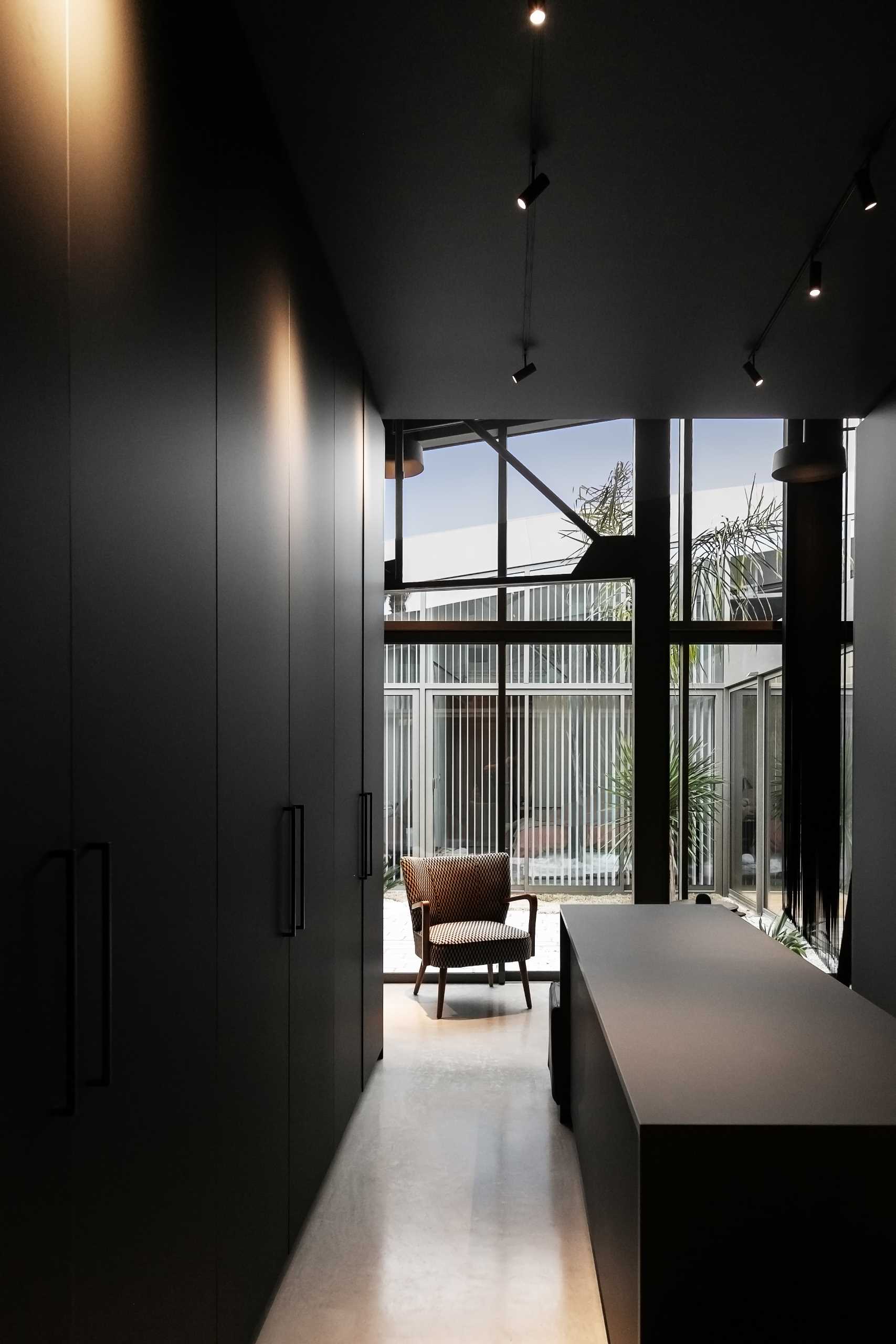 A warehouse conversion with a minimalist black kitchen.