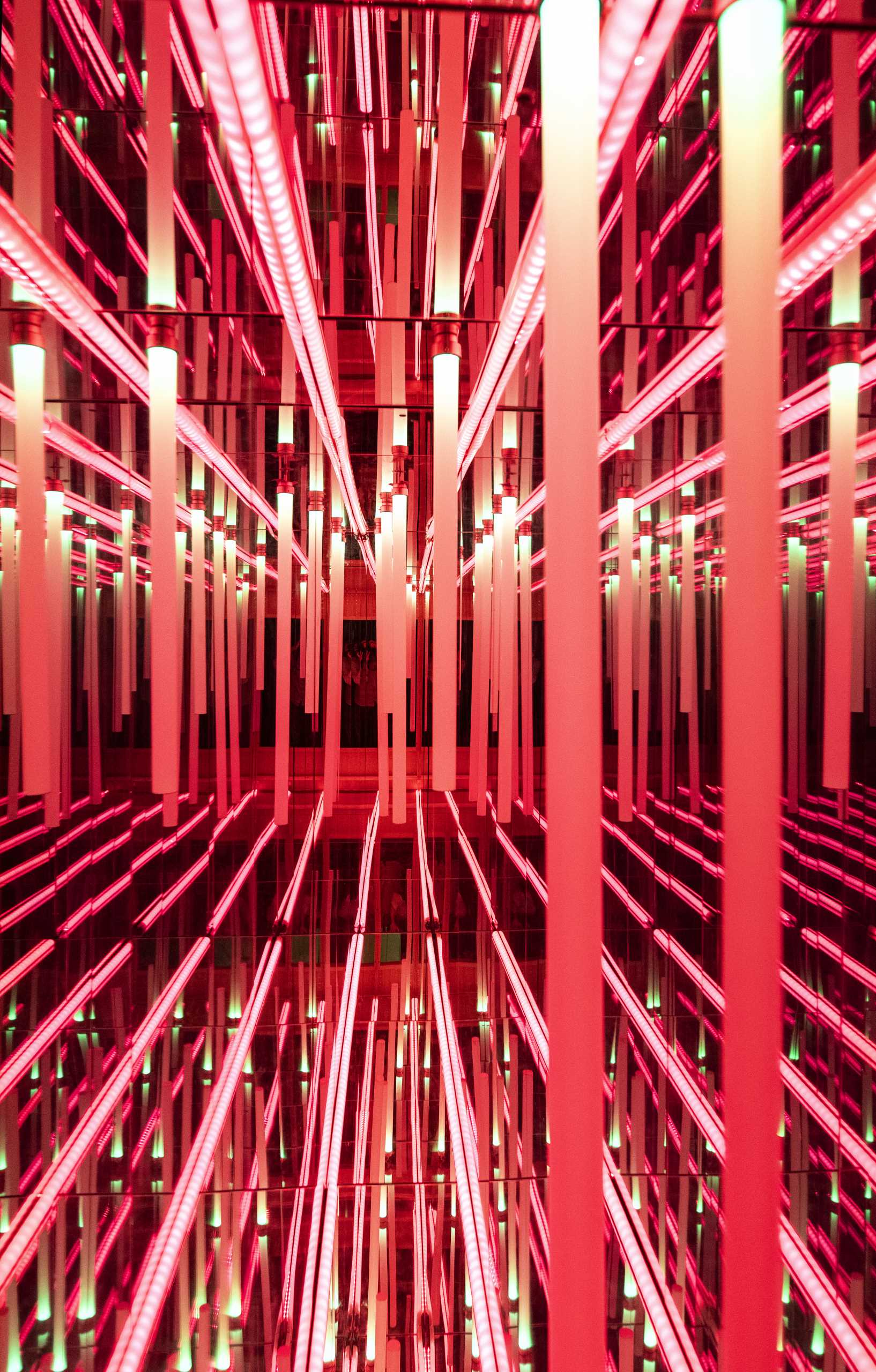 A modern home includes a psychedelic ‘infinity room’ that exists in a foundation quirk. Mirrors, light-tubes, and a wood viewport were used to create a unique lighting installation.