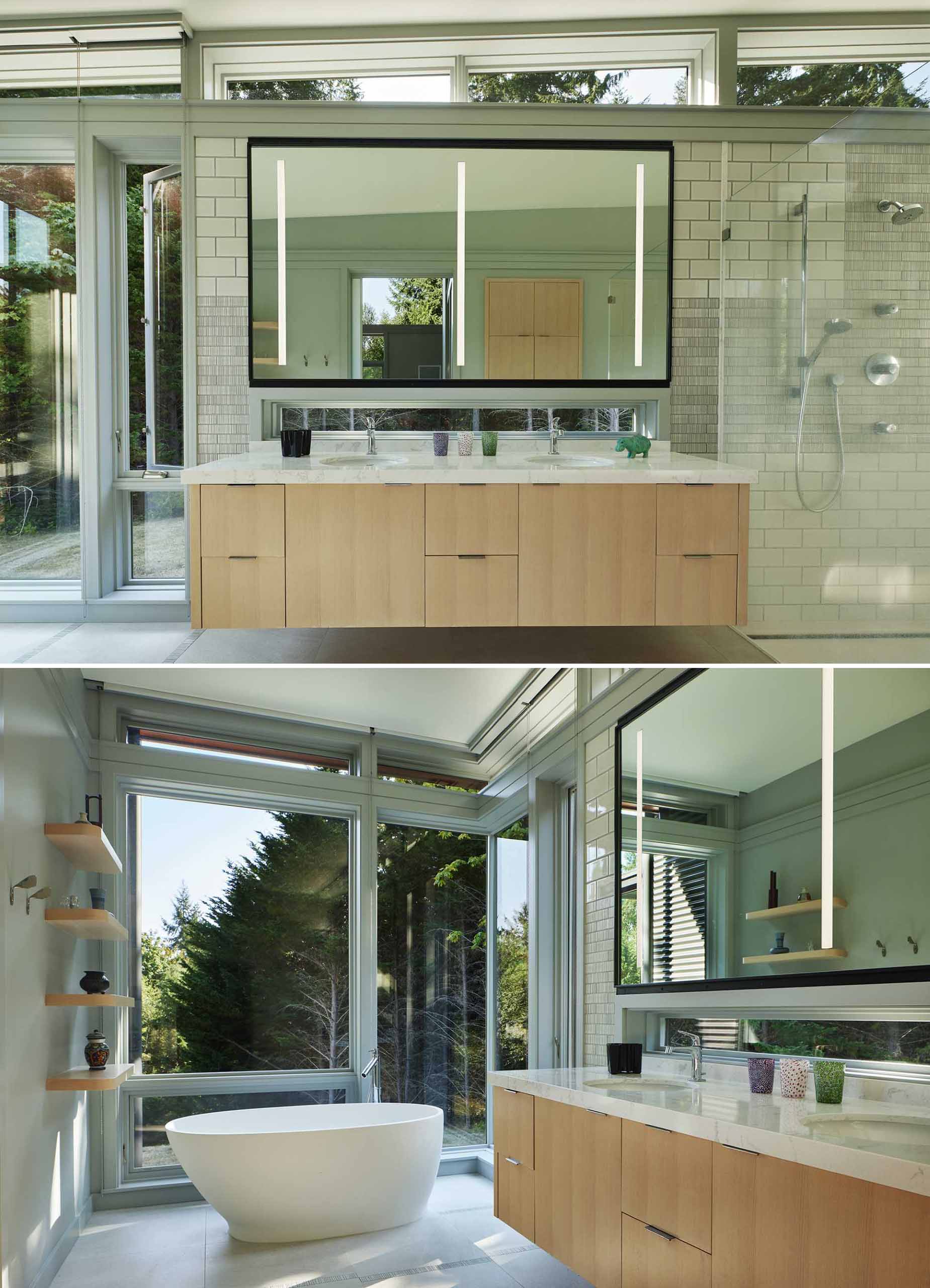 In this modern bathroom, clerestory windows wrap around the room, while the s،wer is located to the right of the vanity, and the bathtub has been positioned by the floor-to-ceiling windows.
