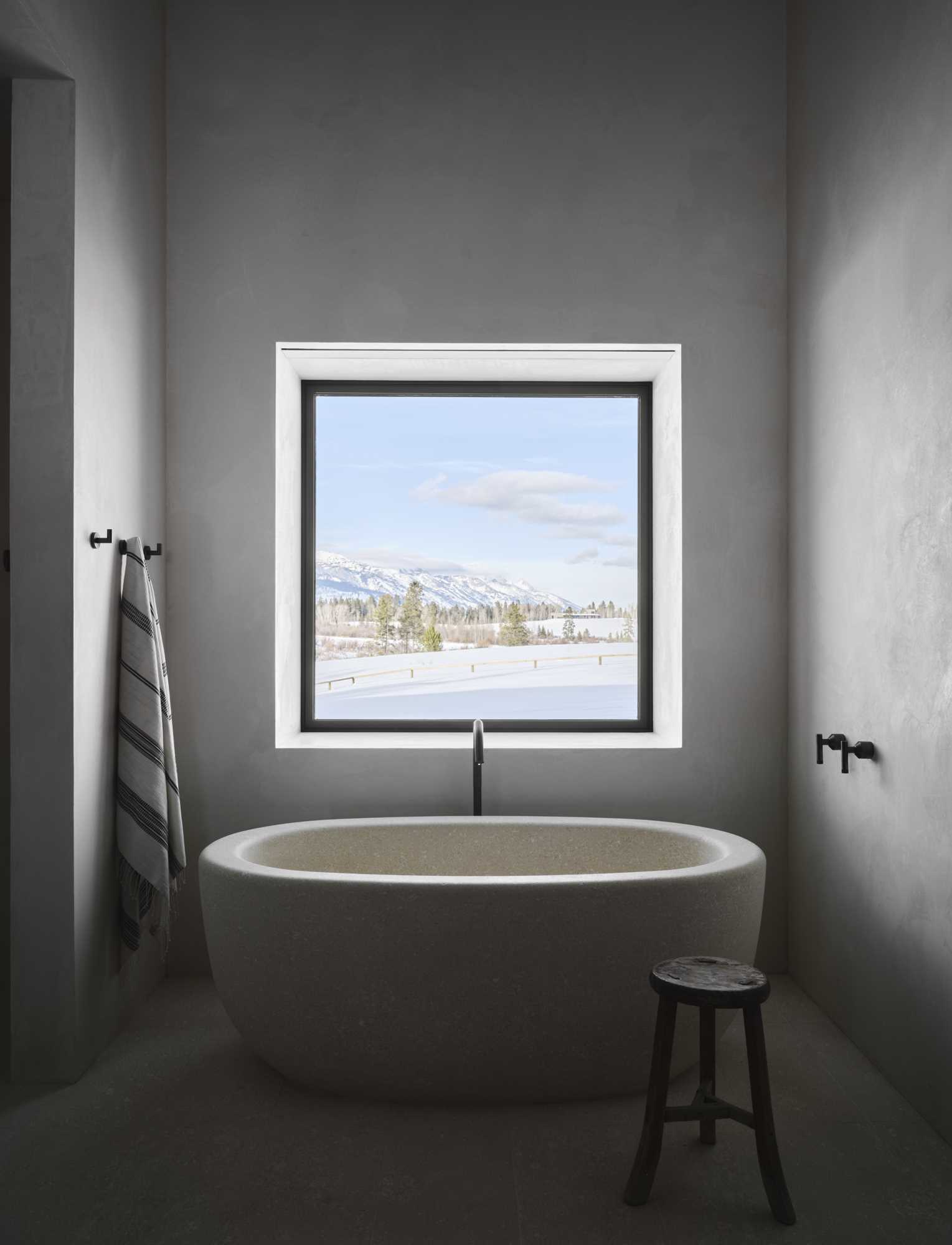 A modern bathtub that's cut from a single block of limestone.