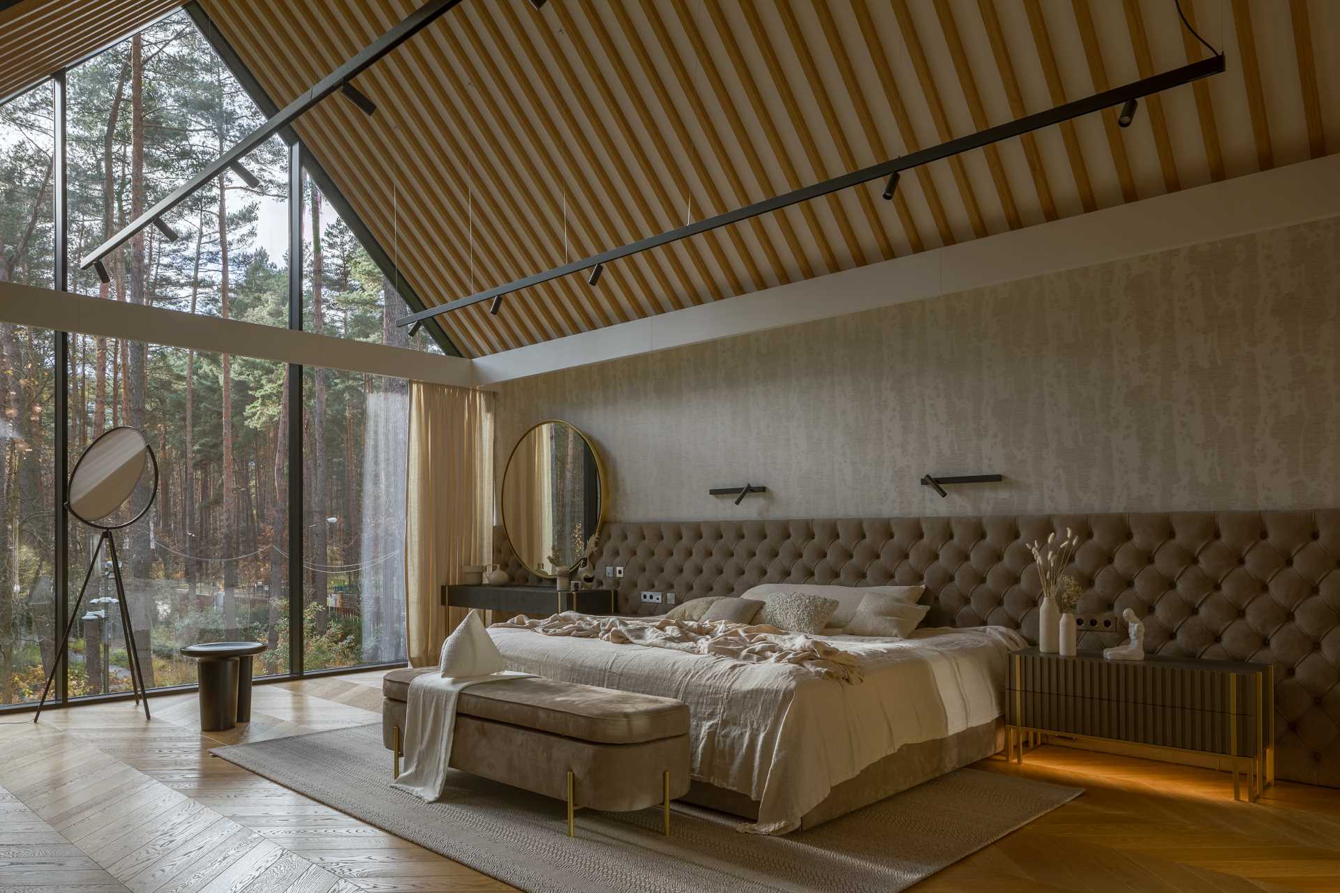 In the master bedroom, a Chesterfield-style quilted headboard that runs the length of the room, and is made of natural suede leather.