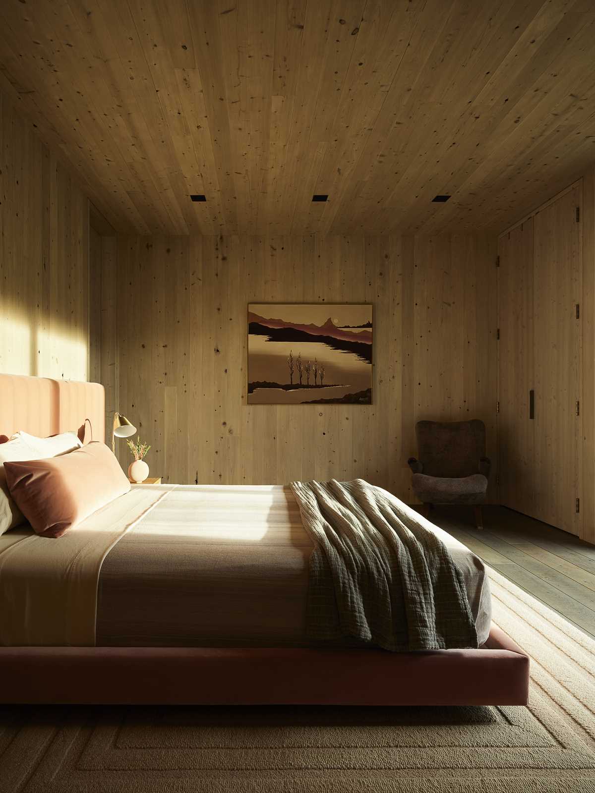 A modern bedroom lined with wood.