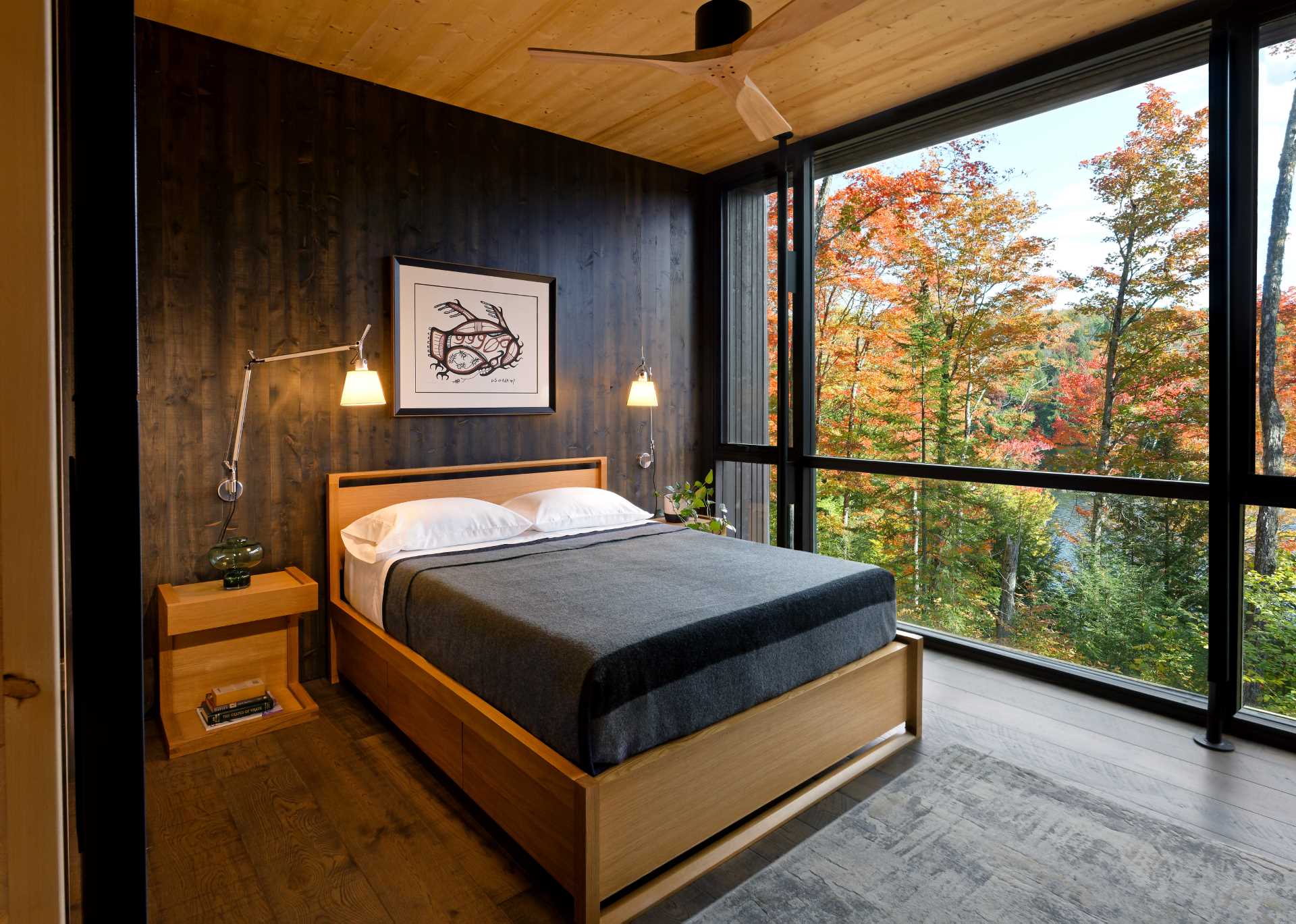 A modern bedroom with a dark wood accent wall.