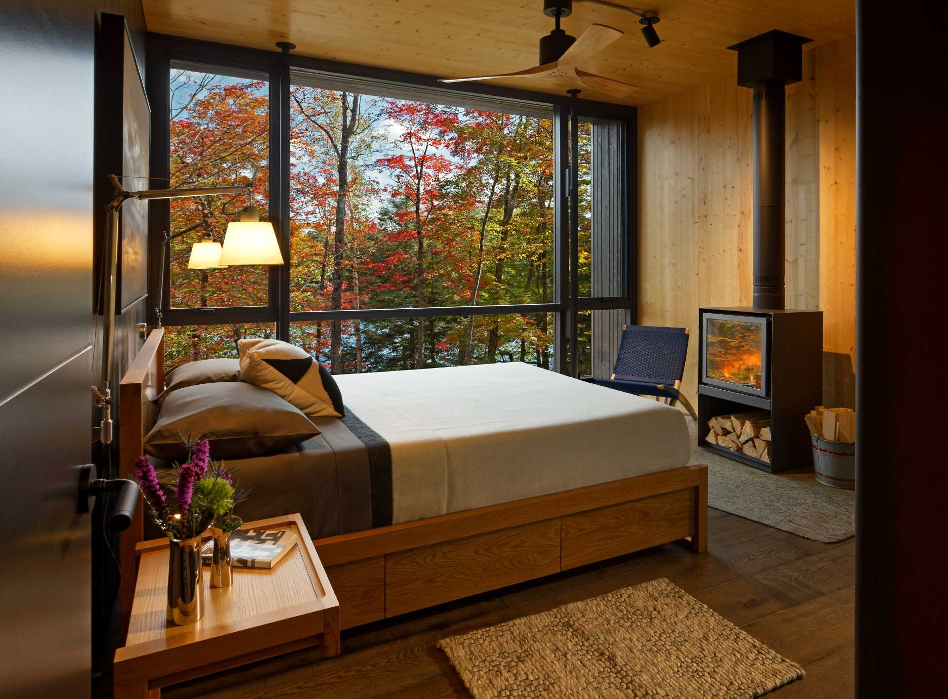 A modern bedroom with a fireplace.