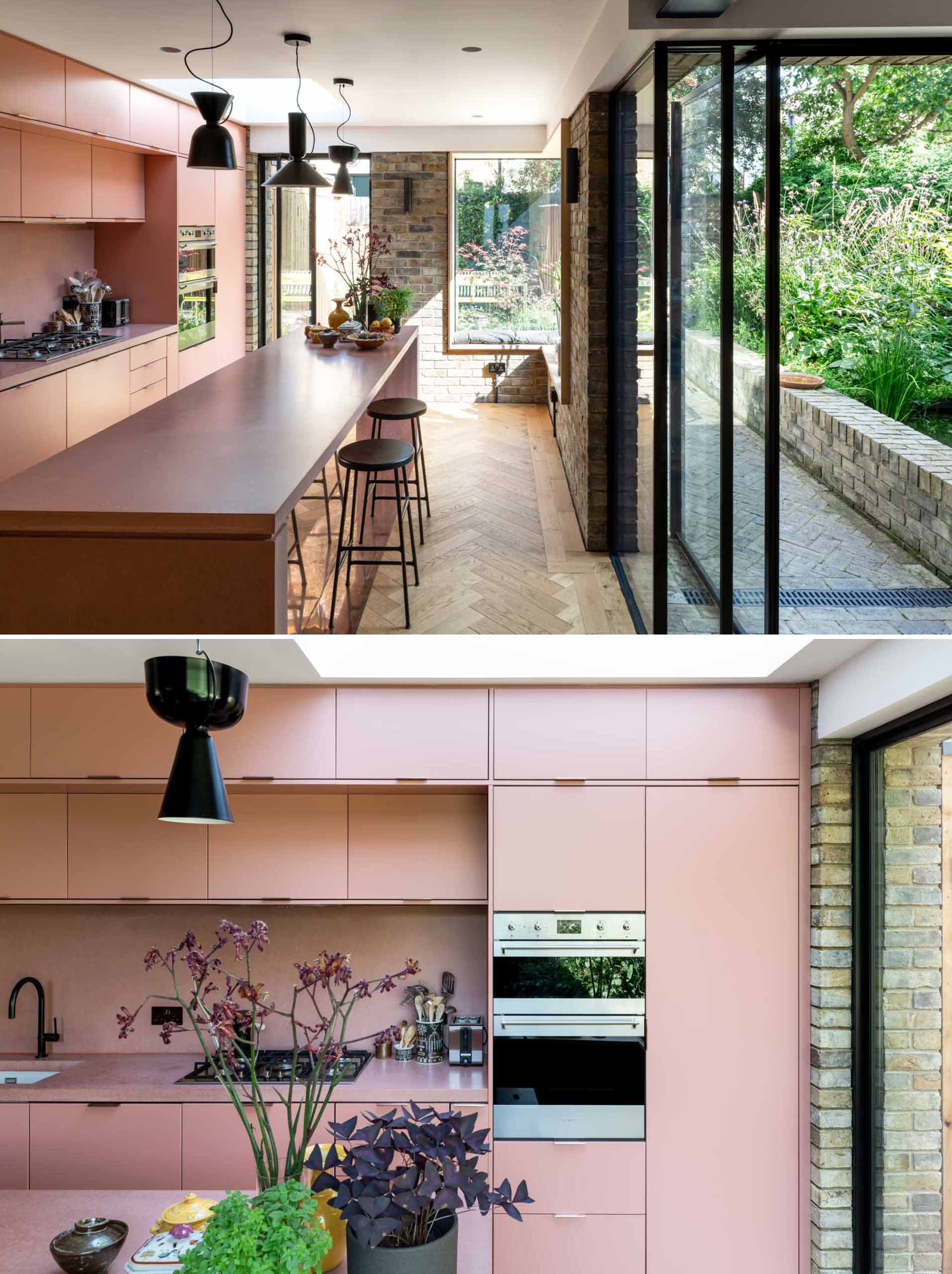 A brick home extension with a blush pink kitchen and window seats.