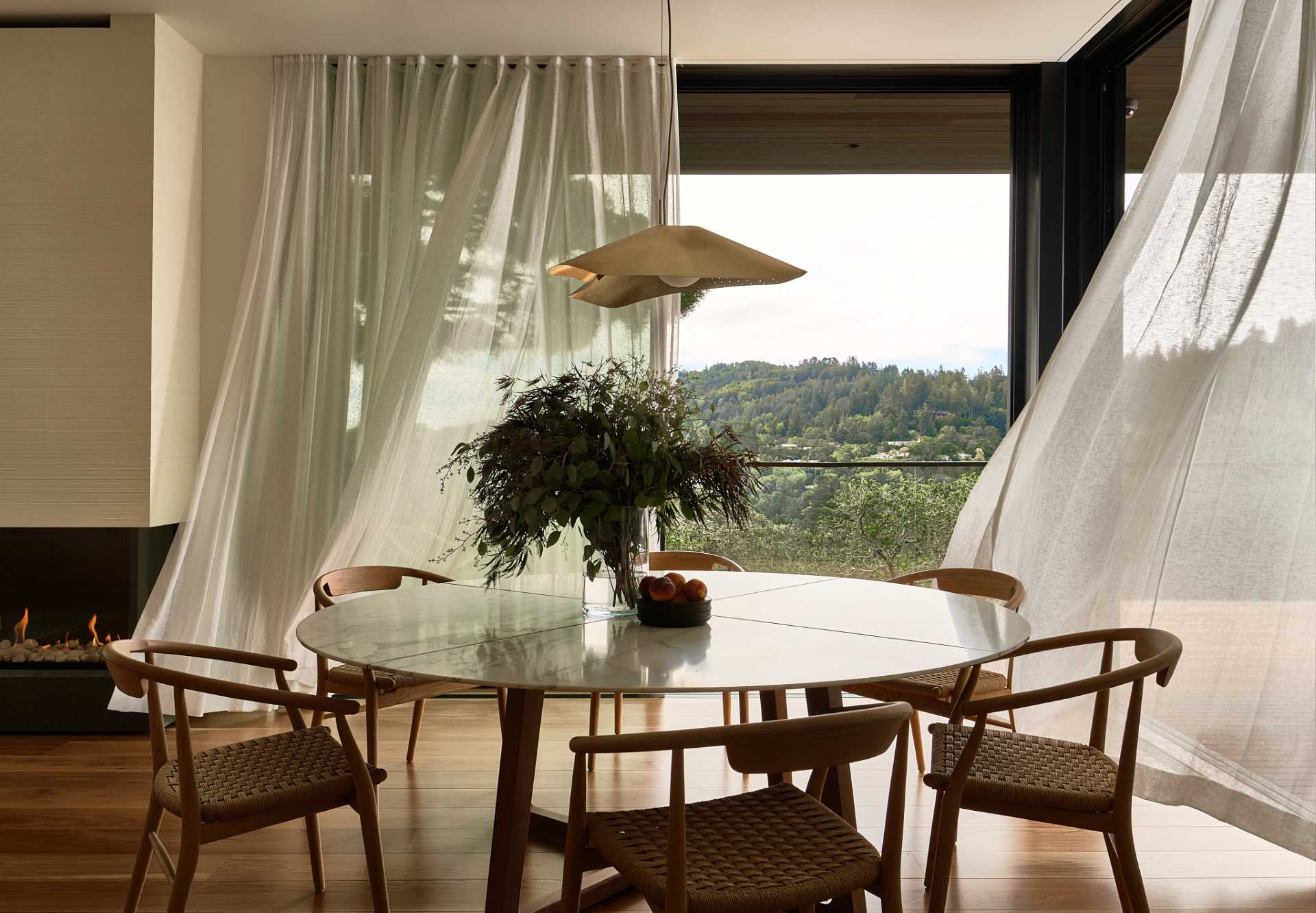 A casual dining area is positioned by sliding glass doors that open to the balcony.