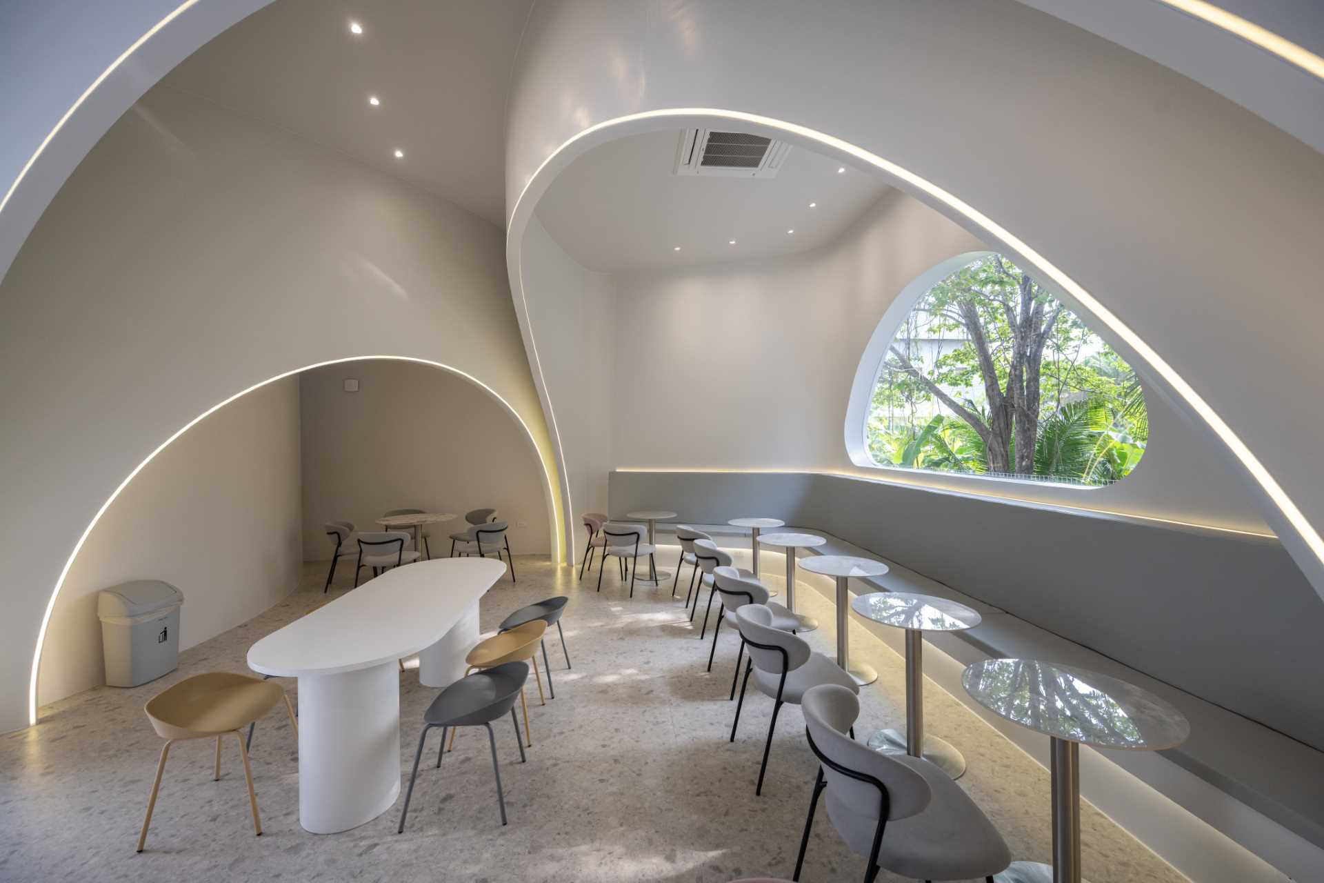 A modern coffee shop where LED lighting highlights the curves and seating areas.