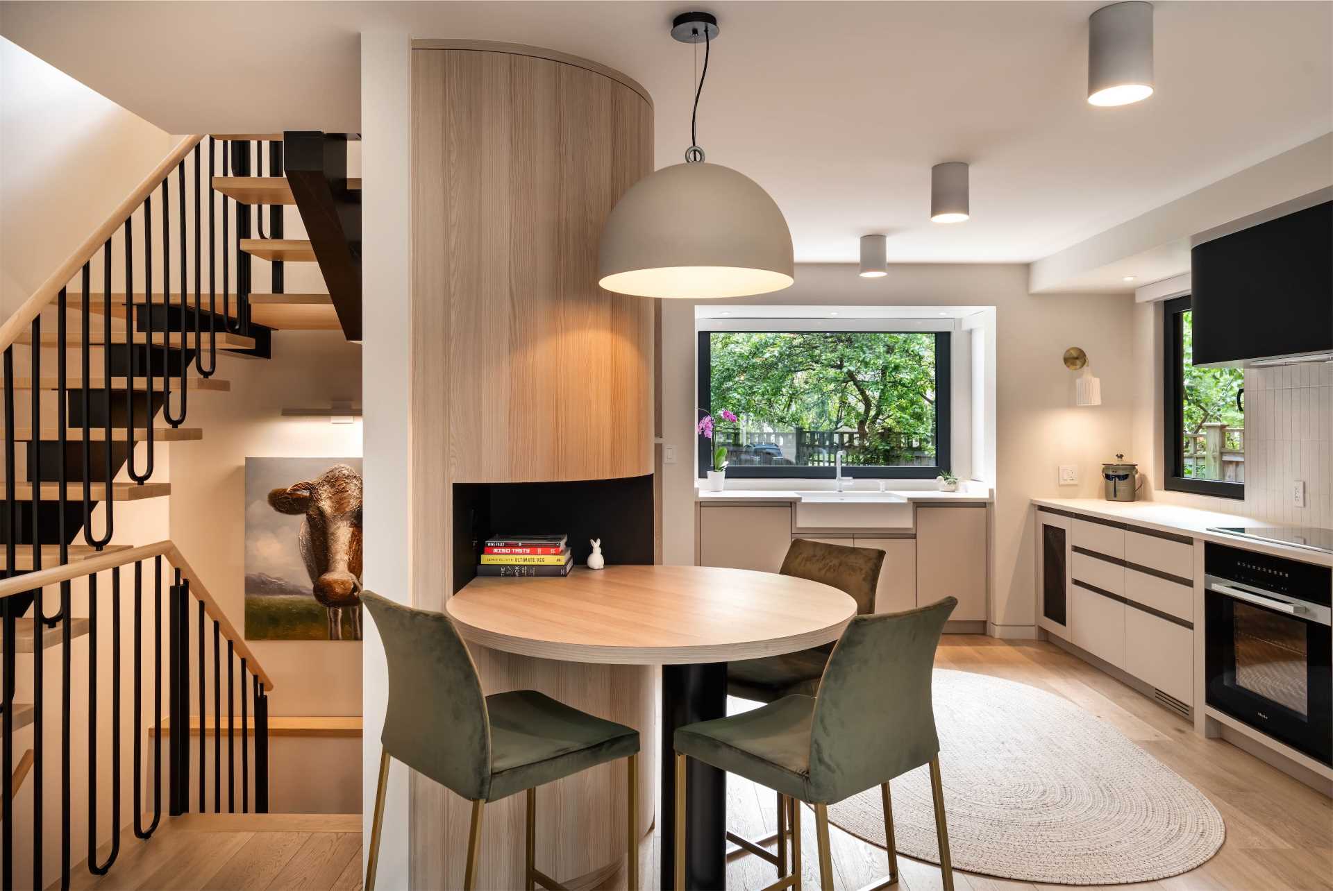 A modern kitchen with a built-in round breakfast bar.