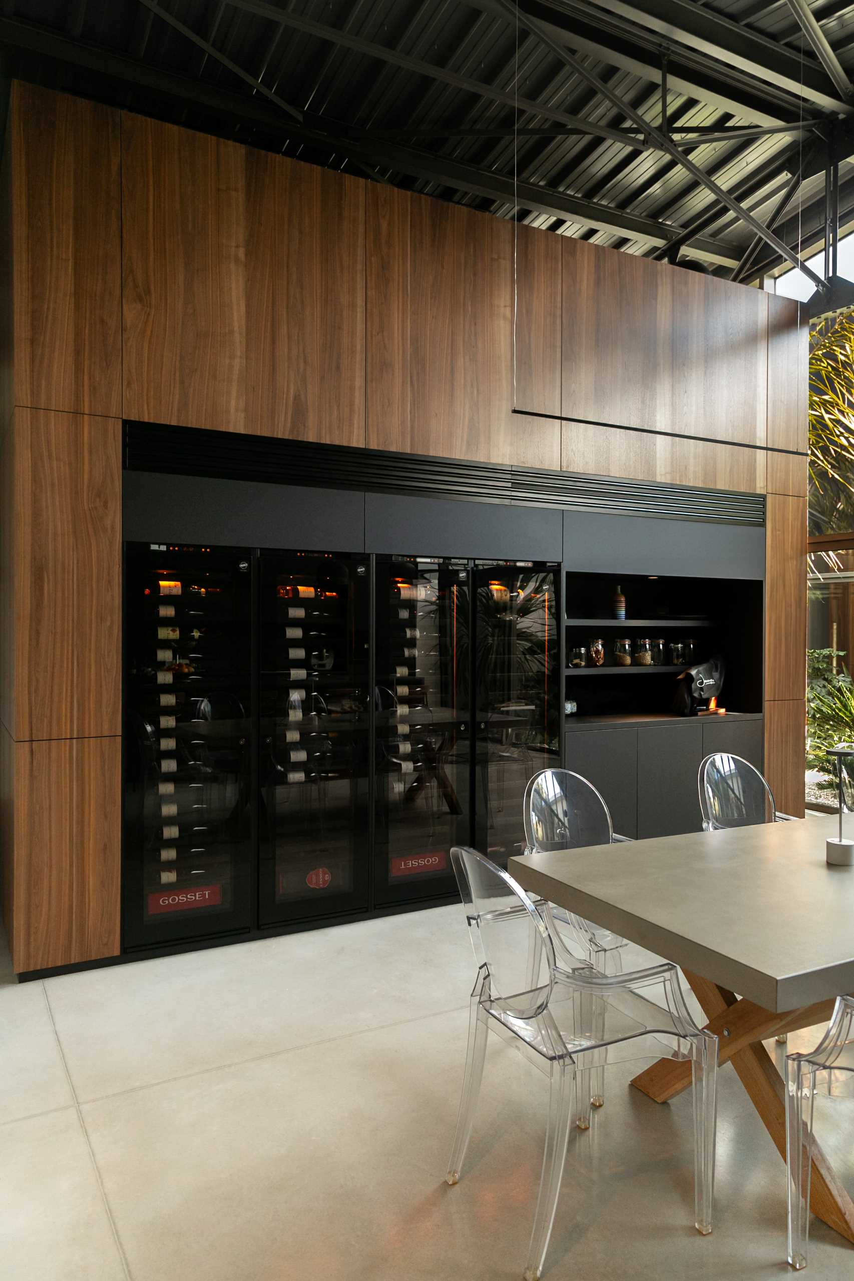 A modern warehouse conversion includes a wine storage wall and bar.