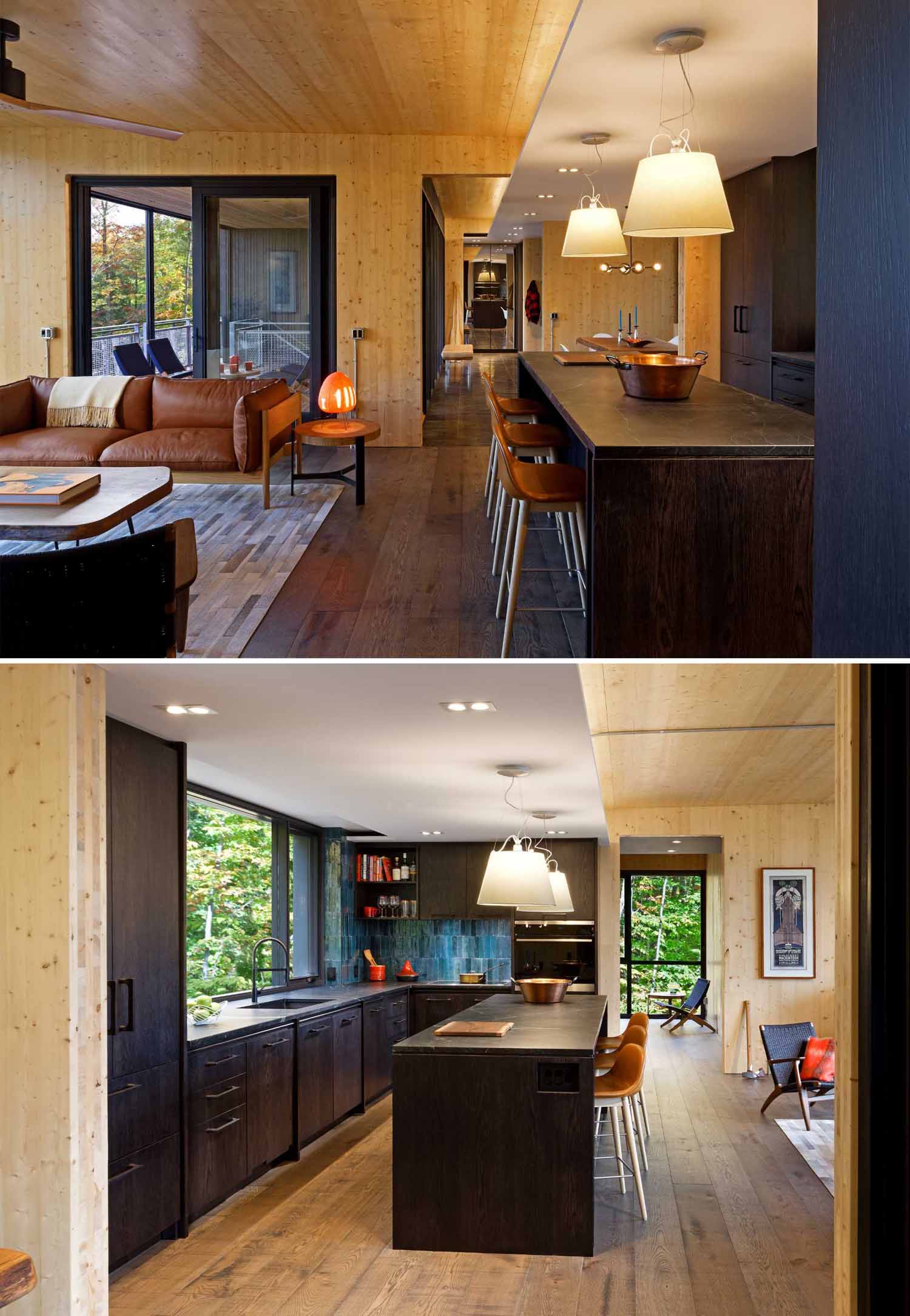 A modern kitchen with dark cabinets, blue tiles, and a large picture window.