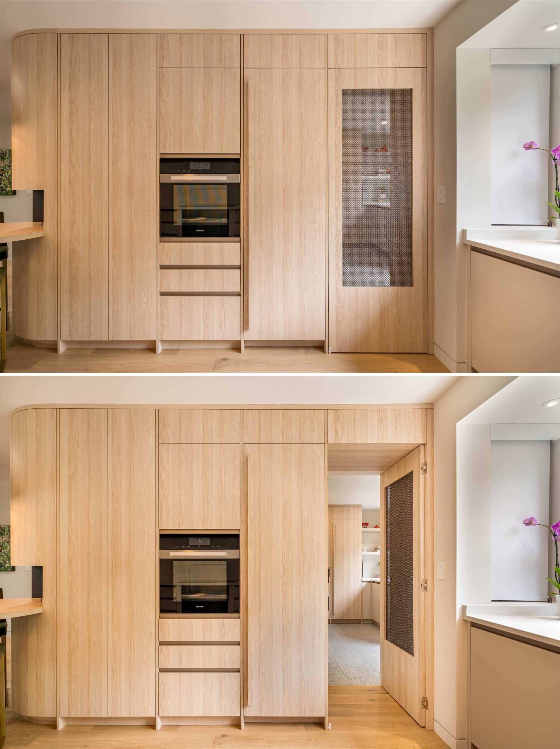 A hidden walk-in pantry is located behind a door with a mesh screen and includes an abundance of storage, additional counter space, and a sink.