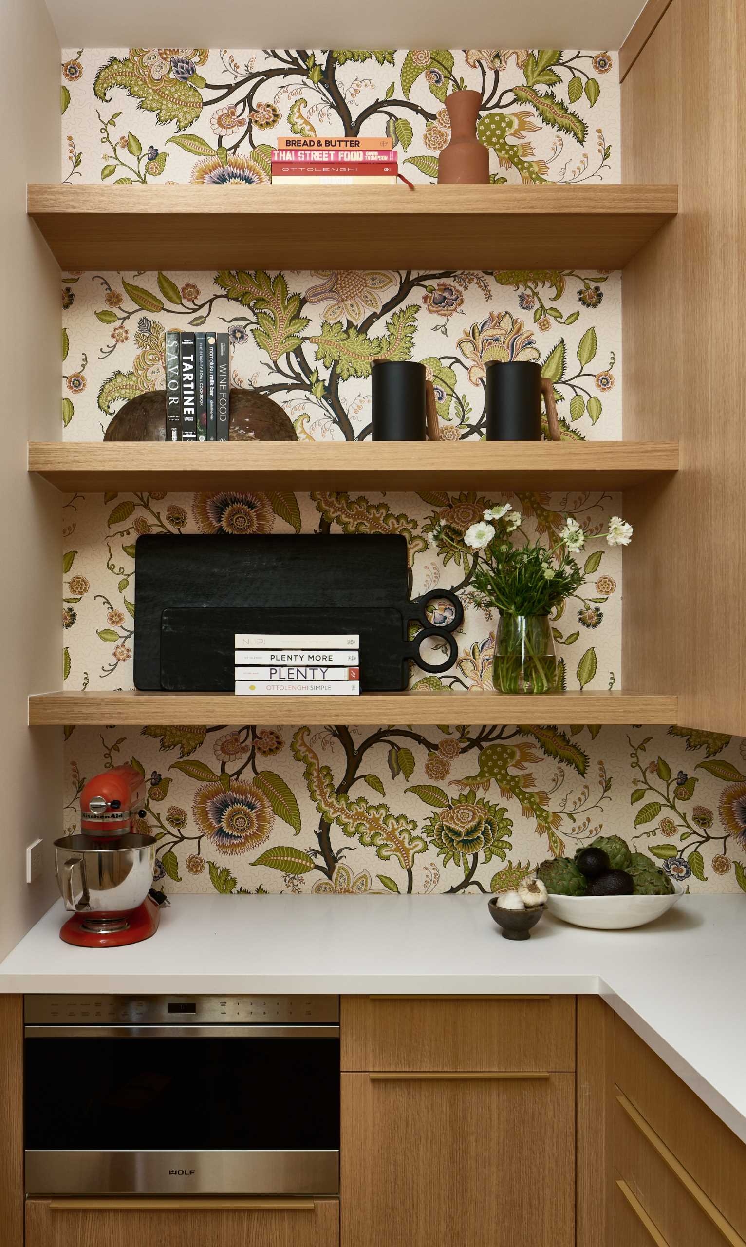 Wallpaper livens up a walk-in pantry.