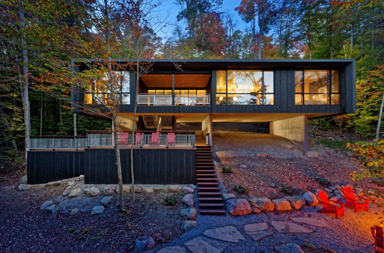 This Lakehouse Hovers Above The Natural Sloped Terrain