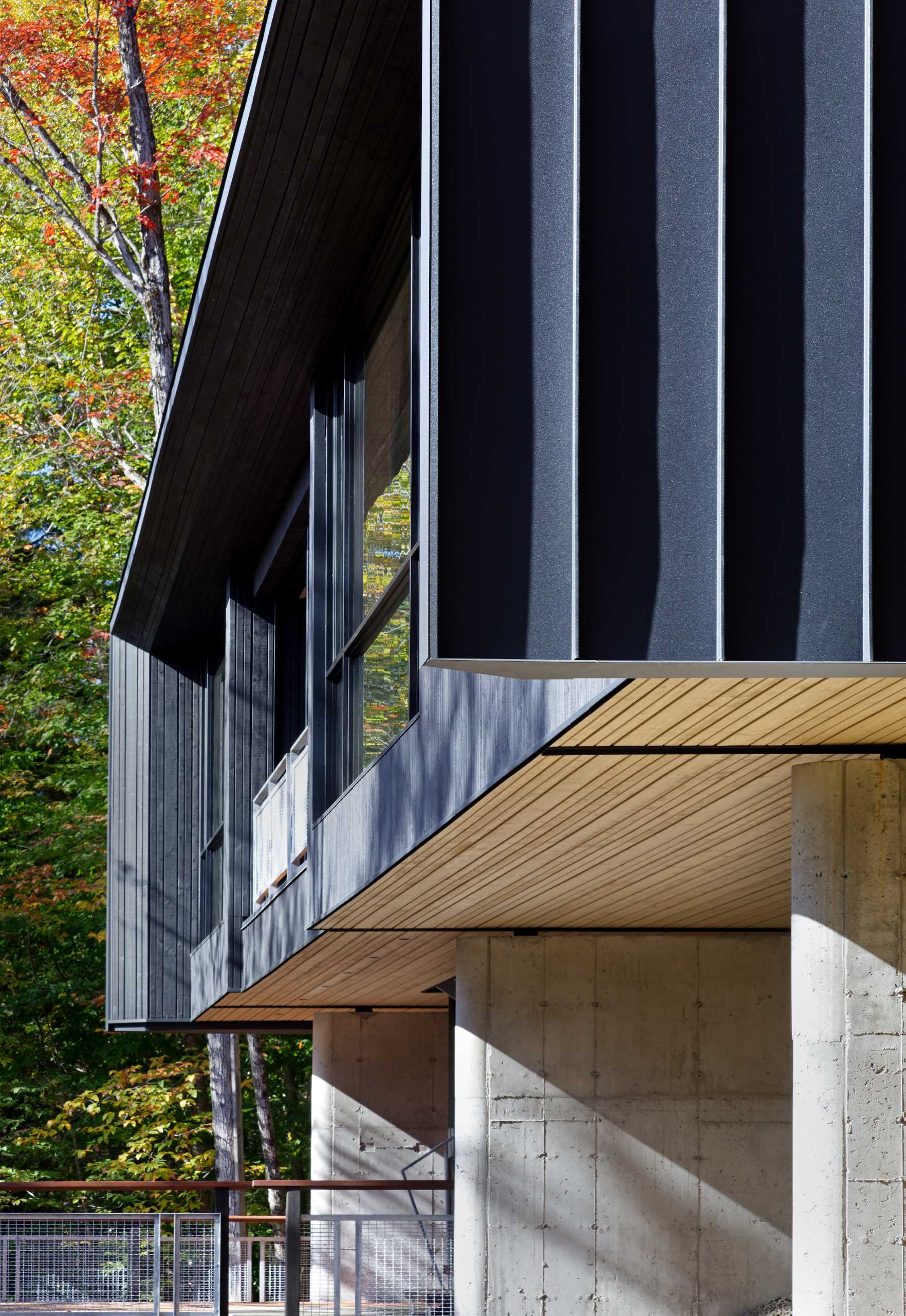 This modern home is supported by three concrete foundation walls anchored to the shallow bedrock and oriented to not impede the flow of the site’s natural drainage and wind patterns. 