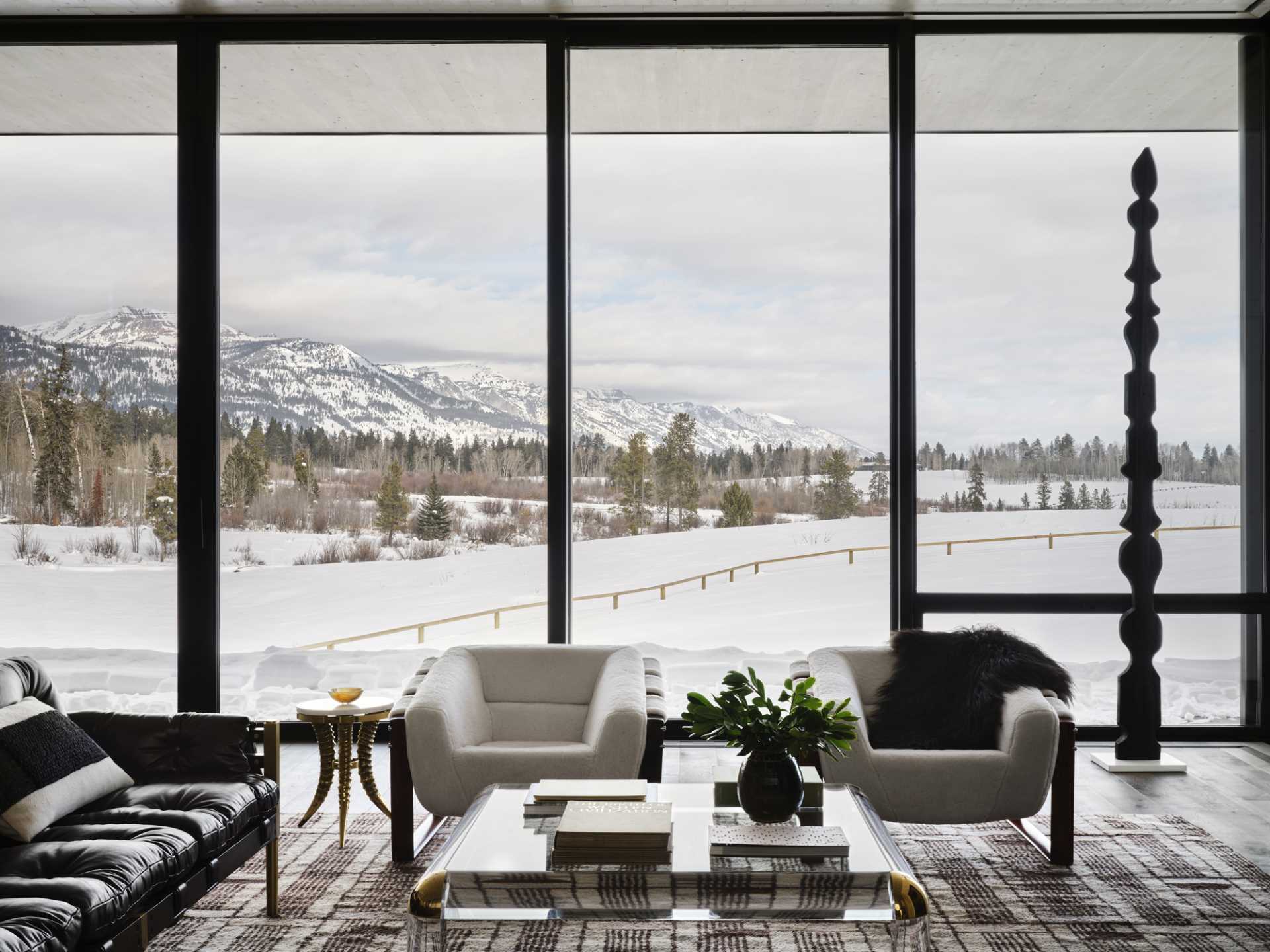 A contemporary living room with floor-to-ceiling windows.