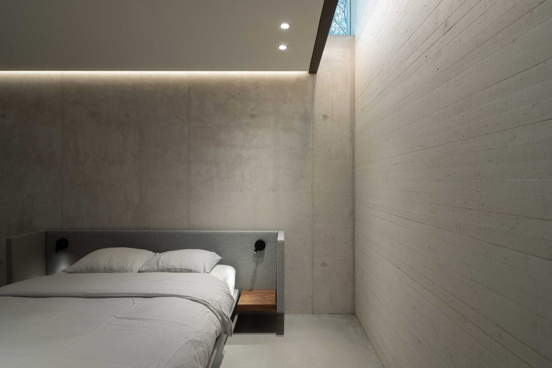 In addition to the stairs, there's also a glass lift that connects all of the levels of the home, like the lowest level which houses a bedroom and bathroom. It's six metres below the entry-level, making it feel like you are underground.
