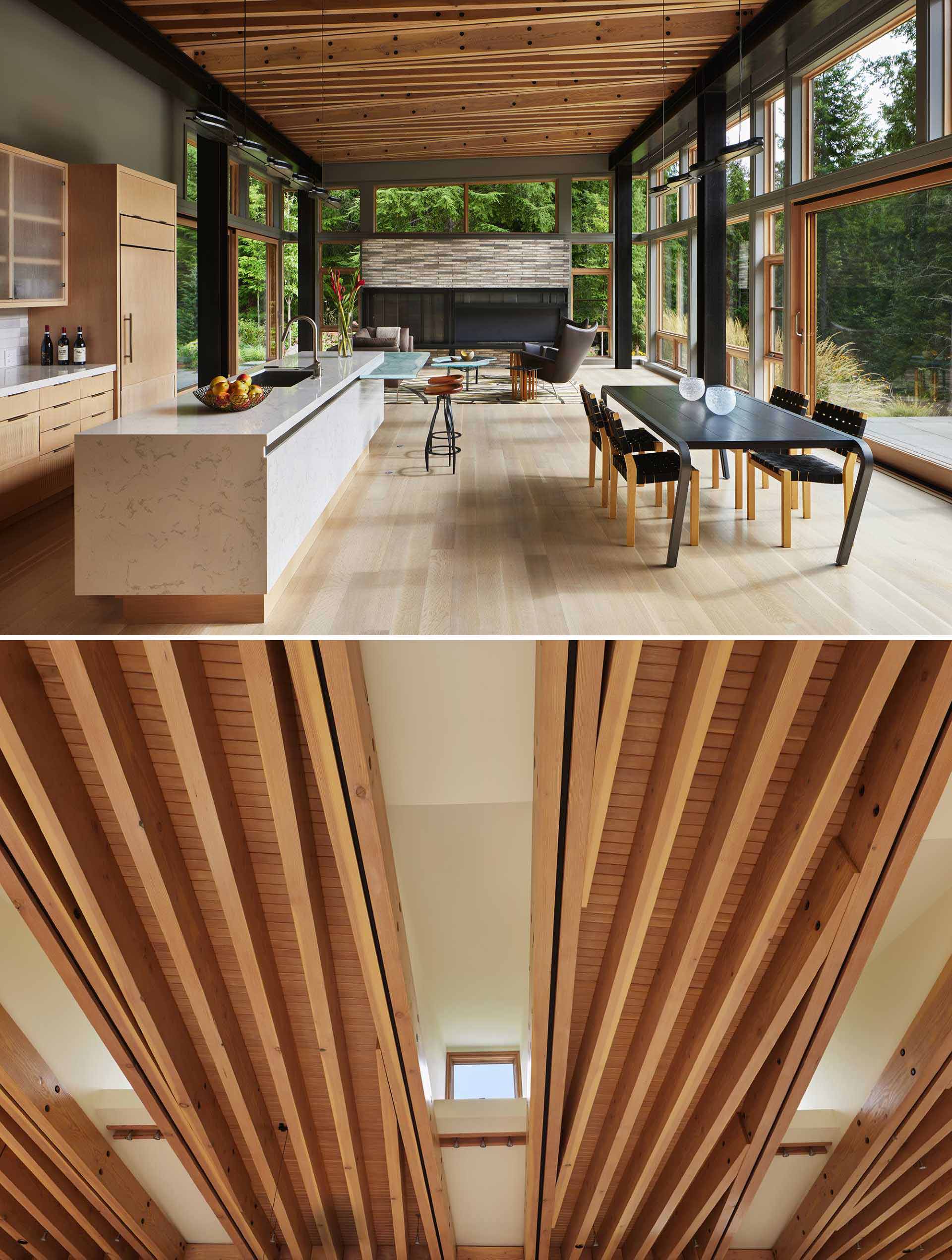Inside, the living pavilion ceiling has a dense pattern of exposed wood beams, interrupted by five shafts of light coming from roof light monitors. Each light monitor is rotated slightly from the orthogonal geometry of the wood beams, so there is a sense of movement across the wood ceiling.