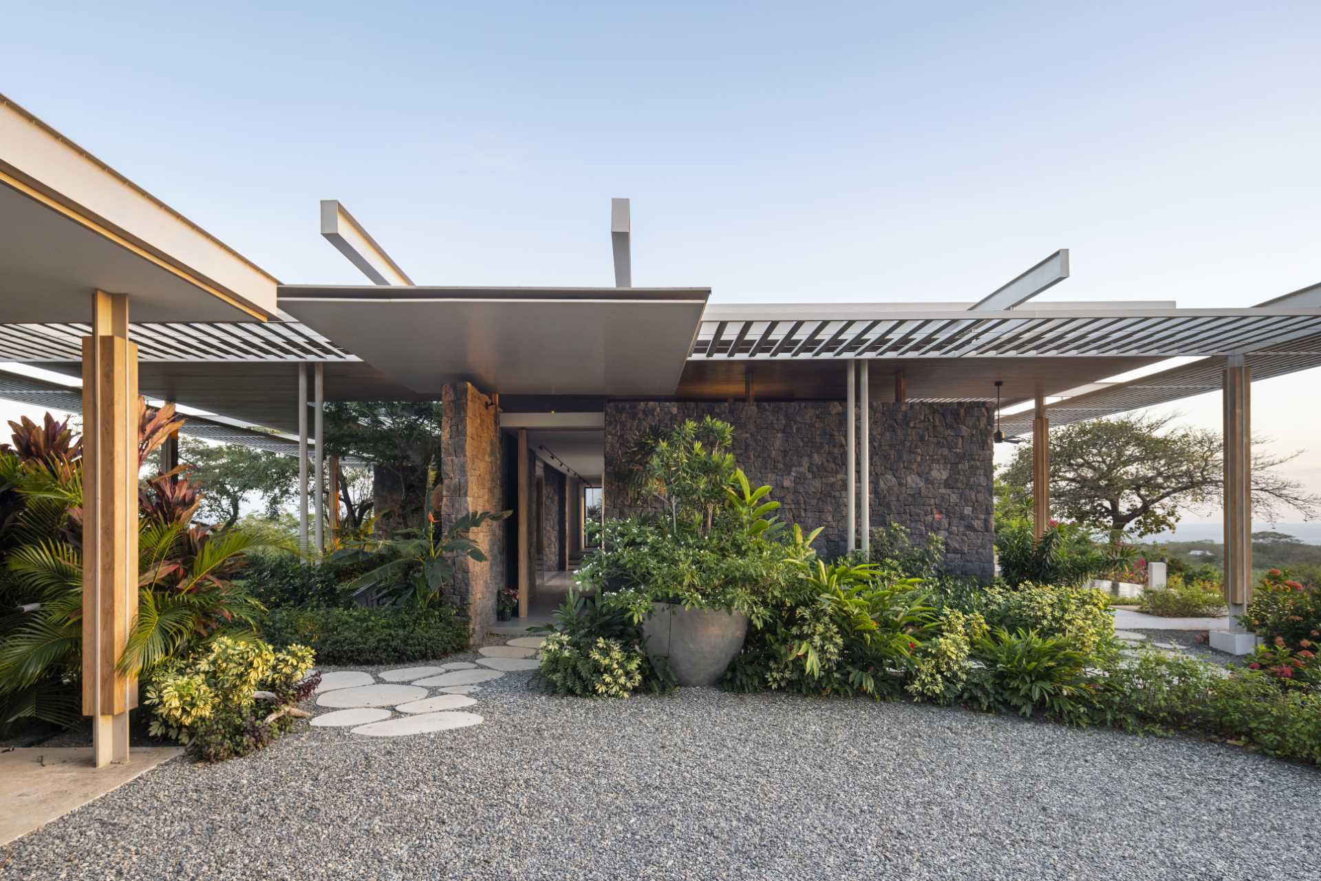 Stepping stone paths lead to the various entryways of this modern home.