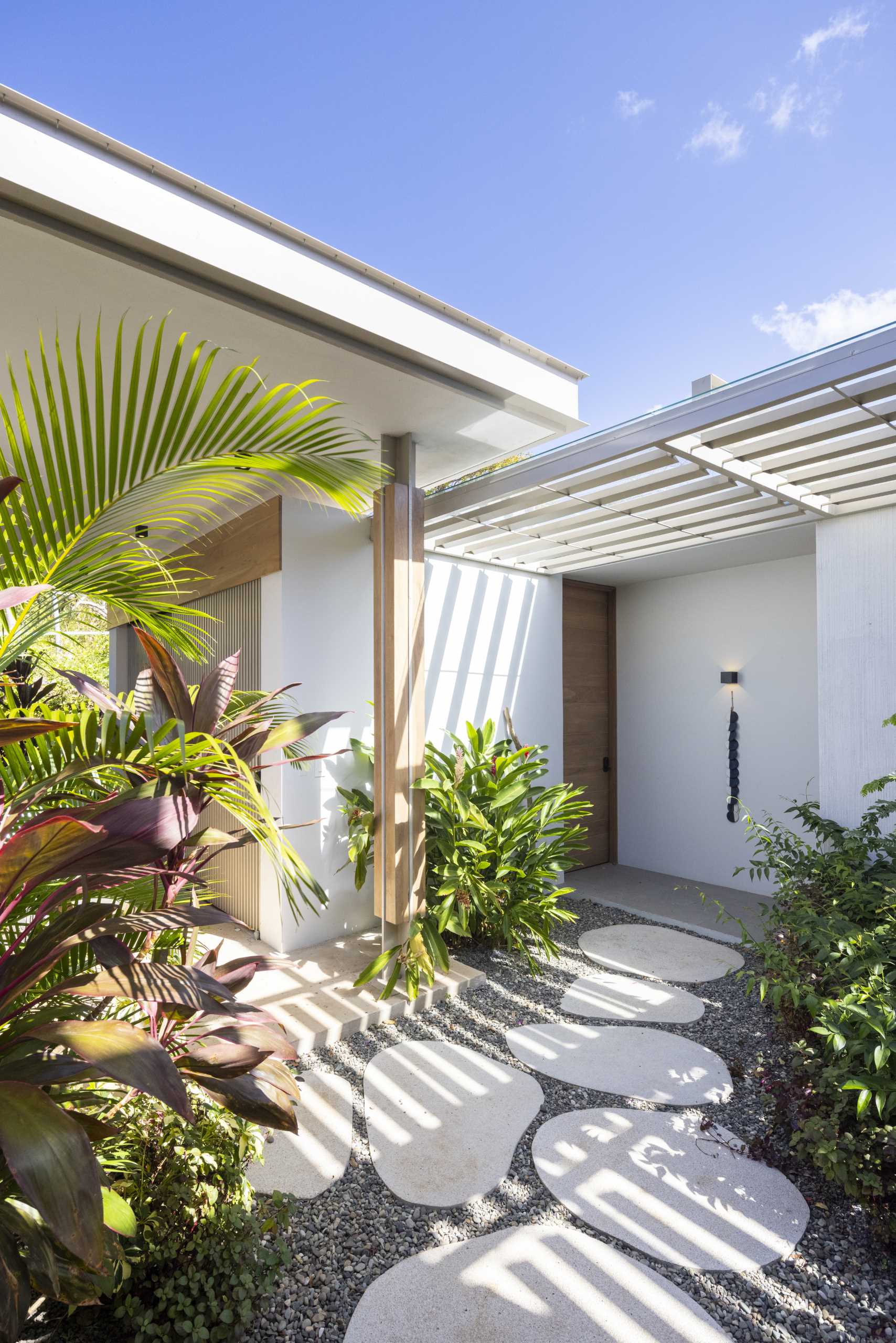 Stepping stone paths lead to the various entryways of this modern home.