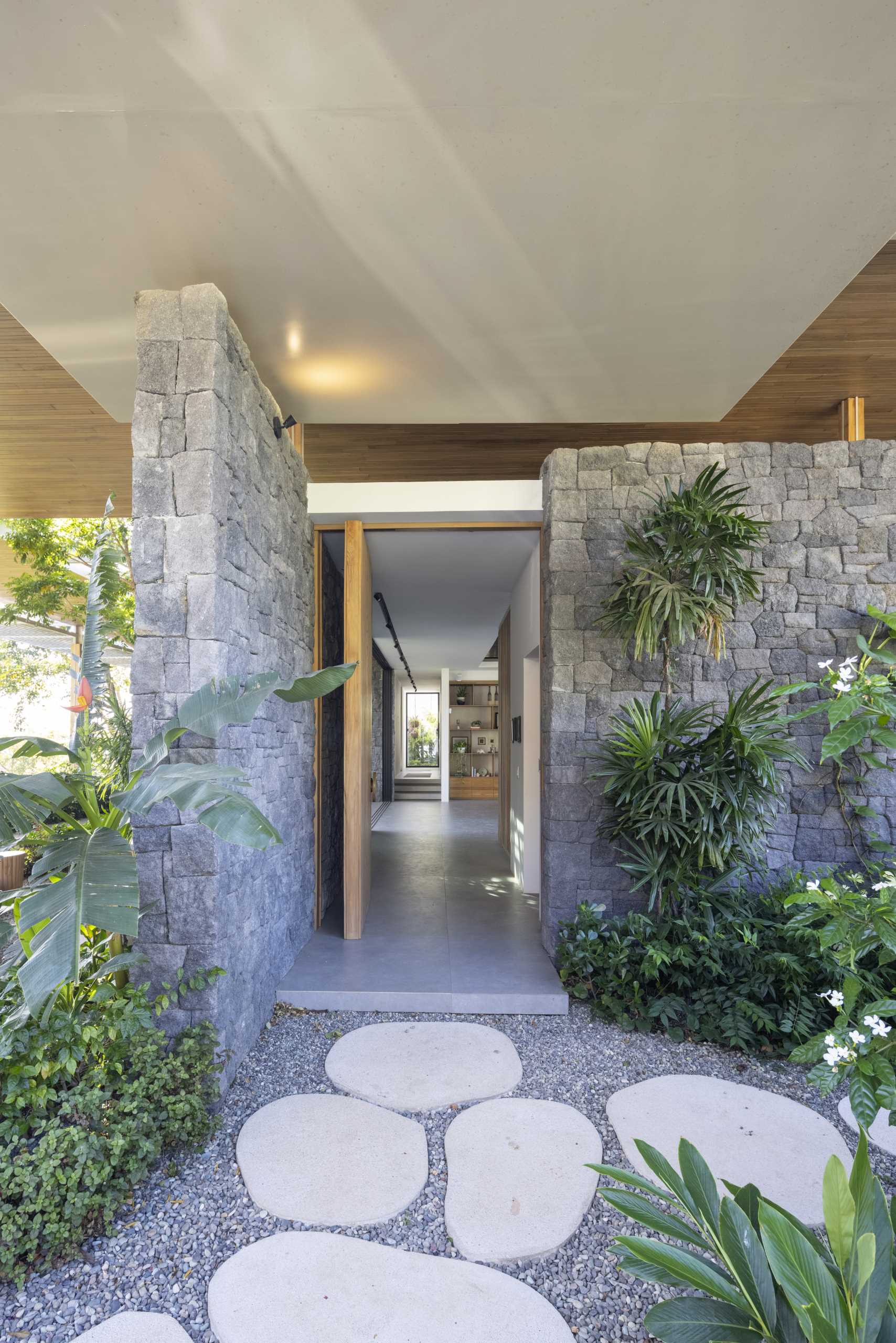 Stepping stone paths lead to the various entryways of this modern home.