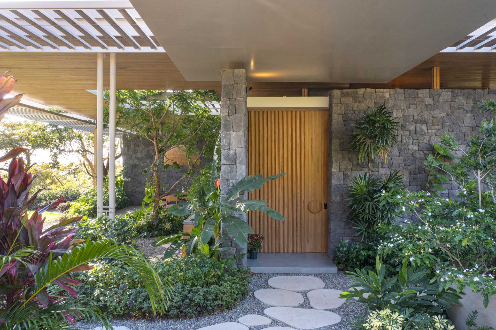 Stepping stone paths lead to the various entryways of this modern home.