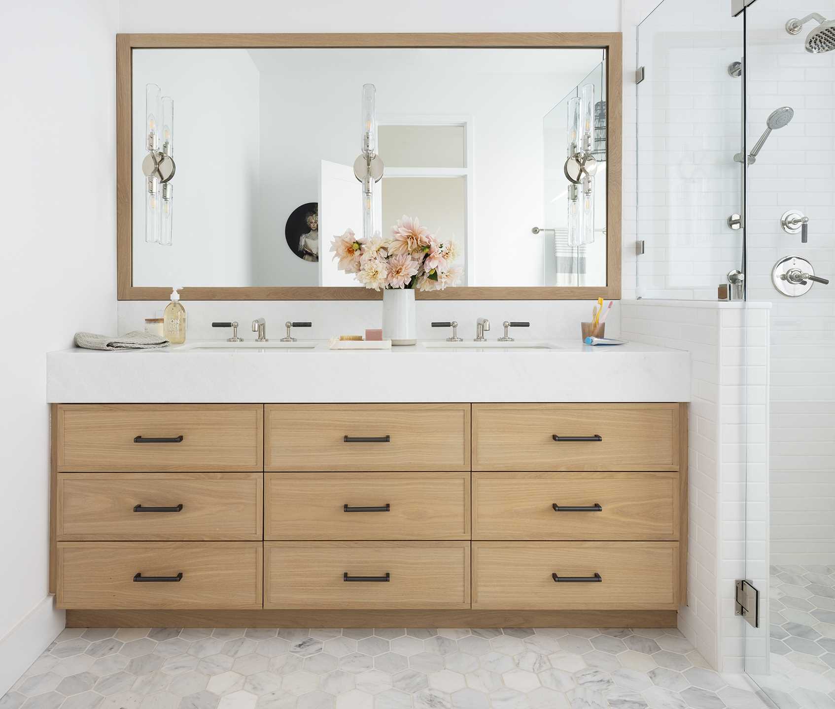 A modern bathroom with a custom-designed wood vanity that fits the space perfectly.
